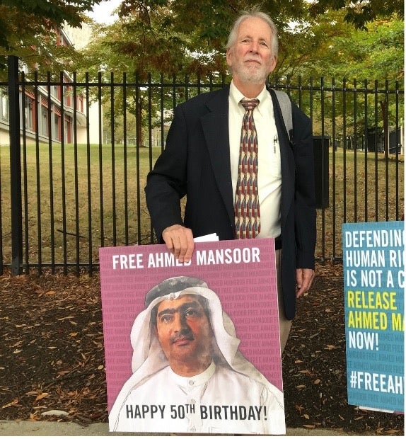 Joe Stork with a poster of Ahmed Mansoor