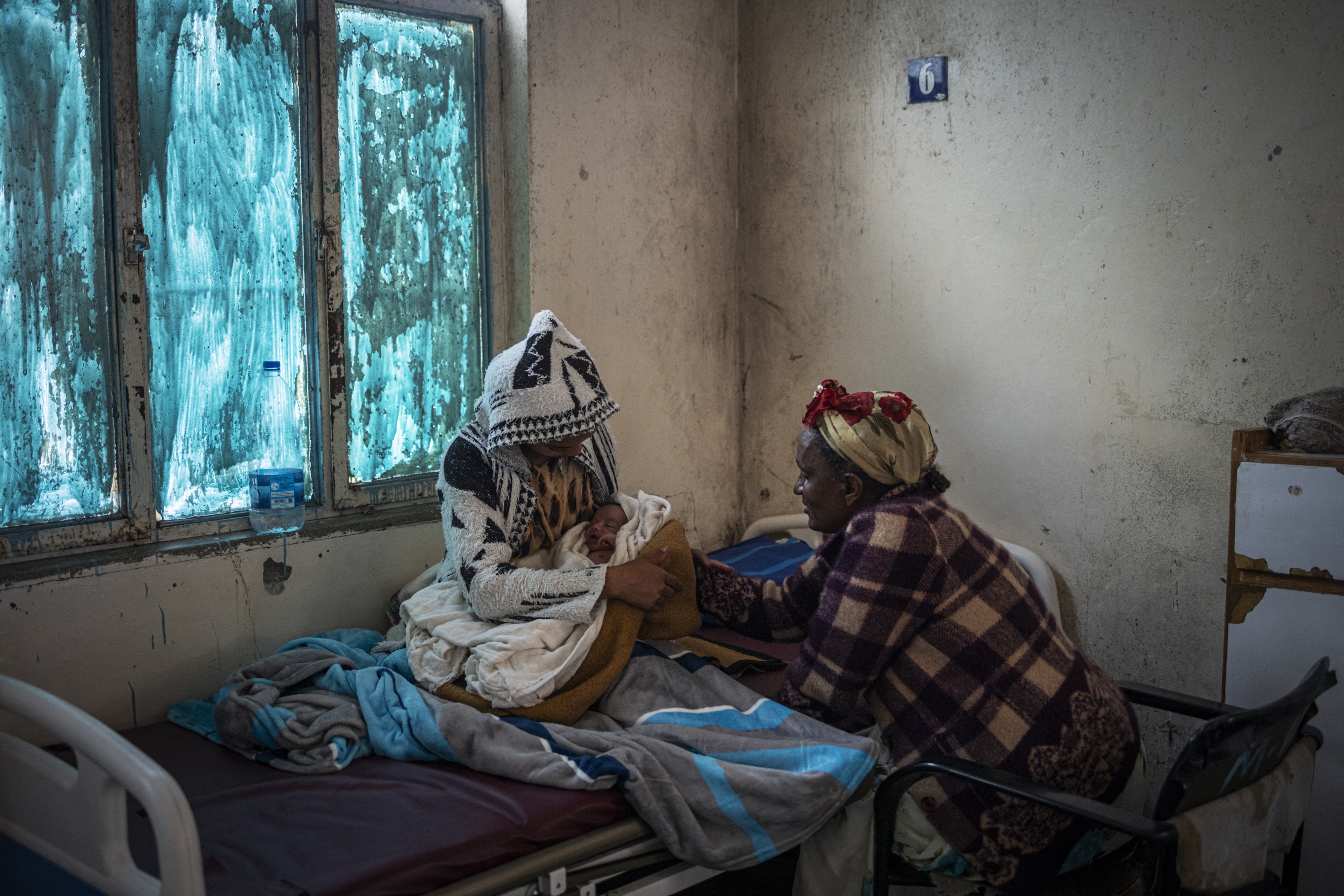A woman rocks her newborn baby at a hospital maternity ward in Mekele, Tigray region, Ethiopia, 2024. 