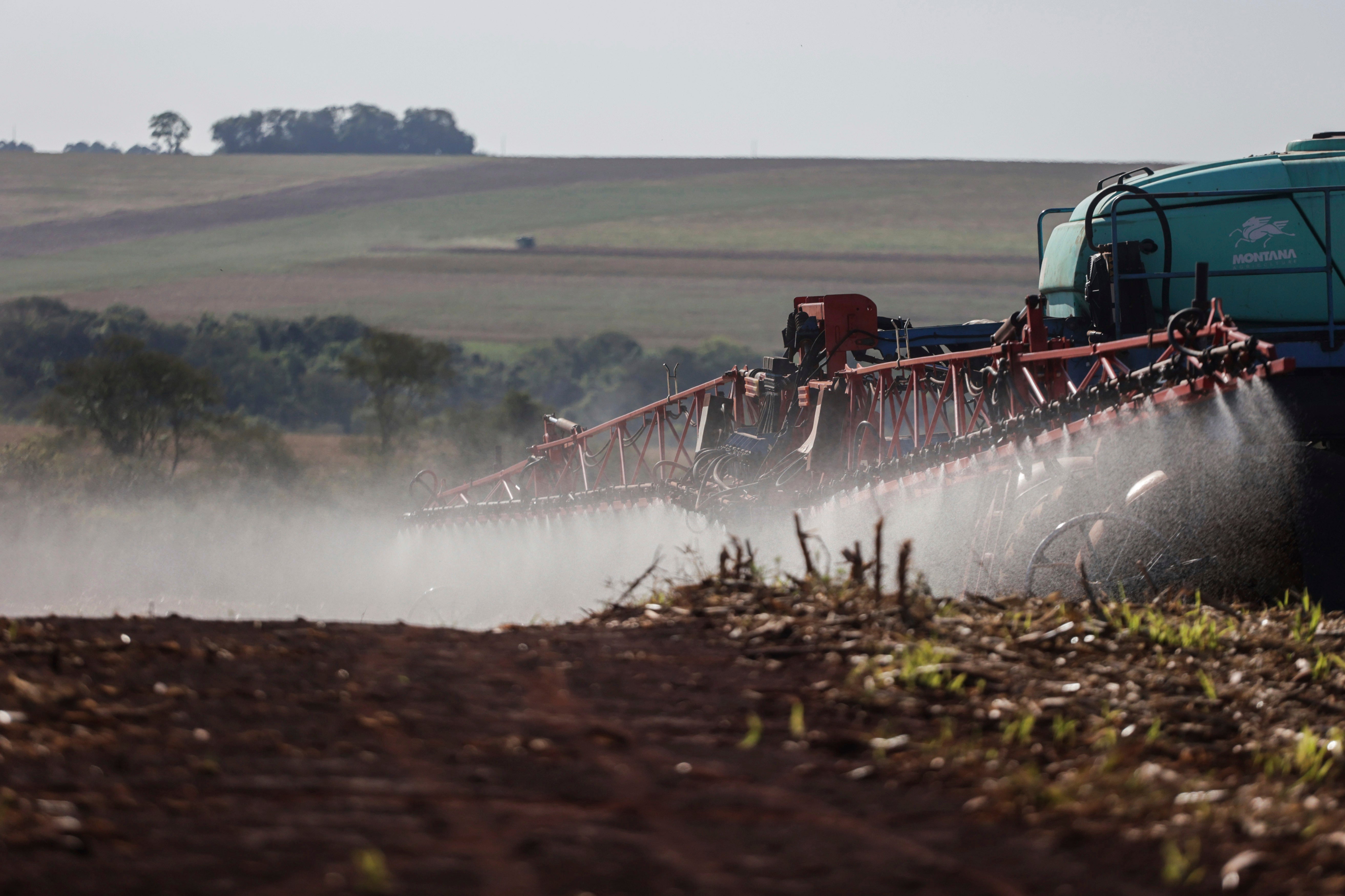 A worker applies fungicide after harvesting soybeans in Campo Mourão, in the Central-West Region of Paraná, Brazil, October 14, 2021. 