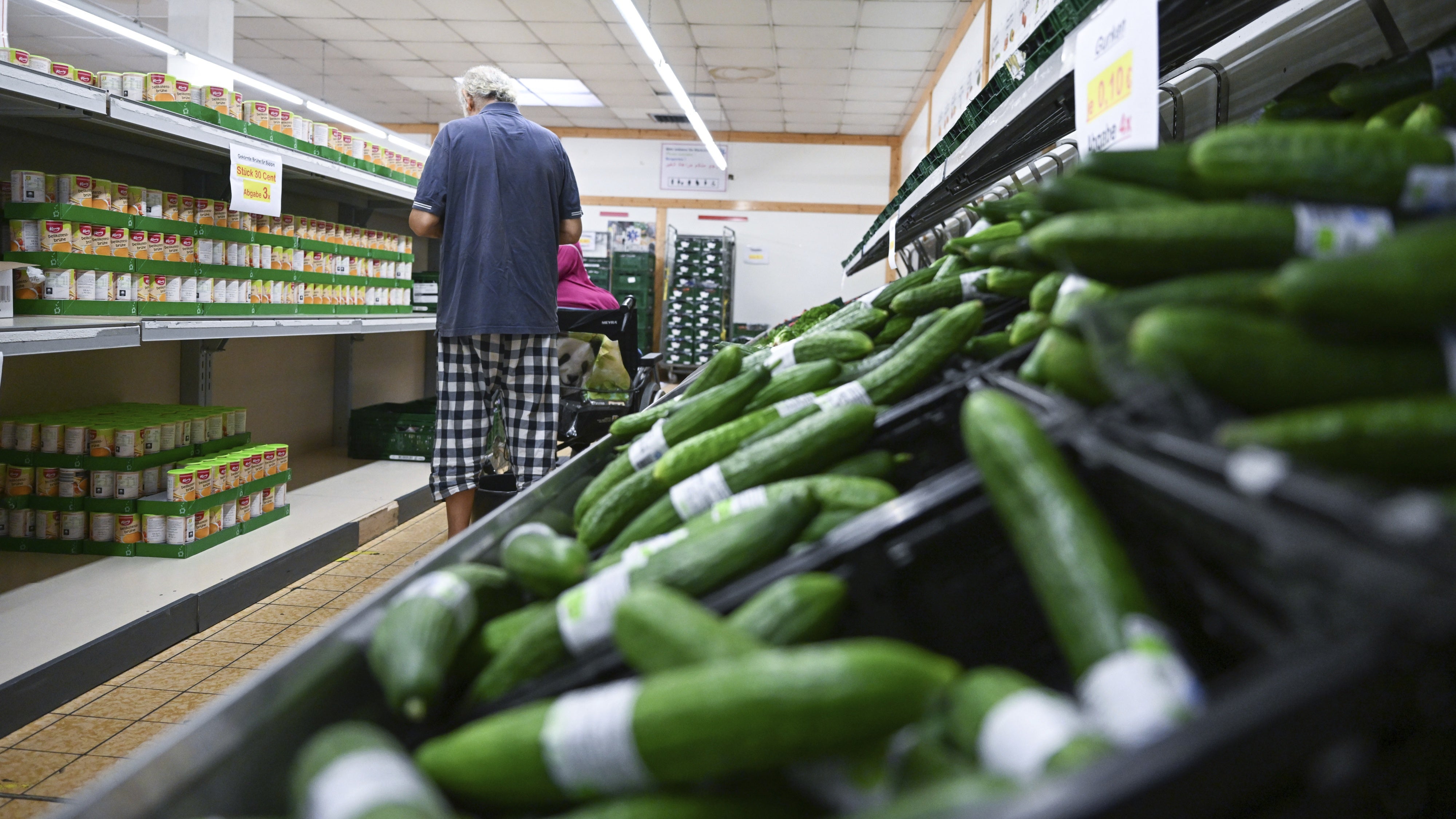 People choose groceries at a food bank in Stuttgart, Baden-Wurttemberg, Germany, July 21, 2022. 