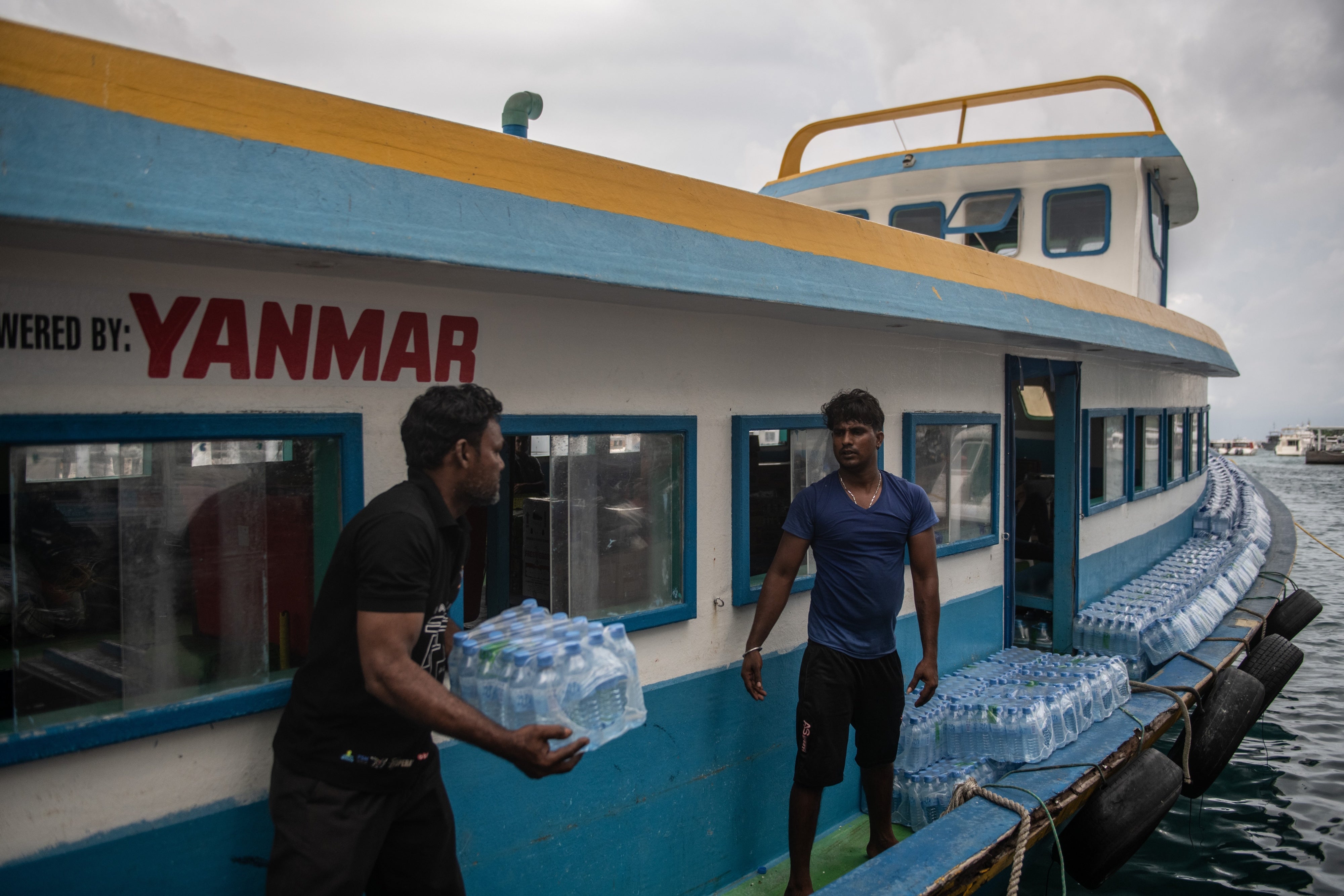 Bottled water is loaded onto a boat for delivery to another island in Malé, Maldives, December 18, 2019.