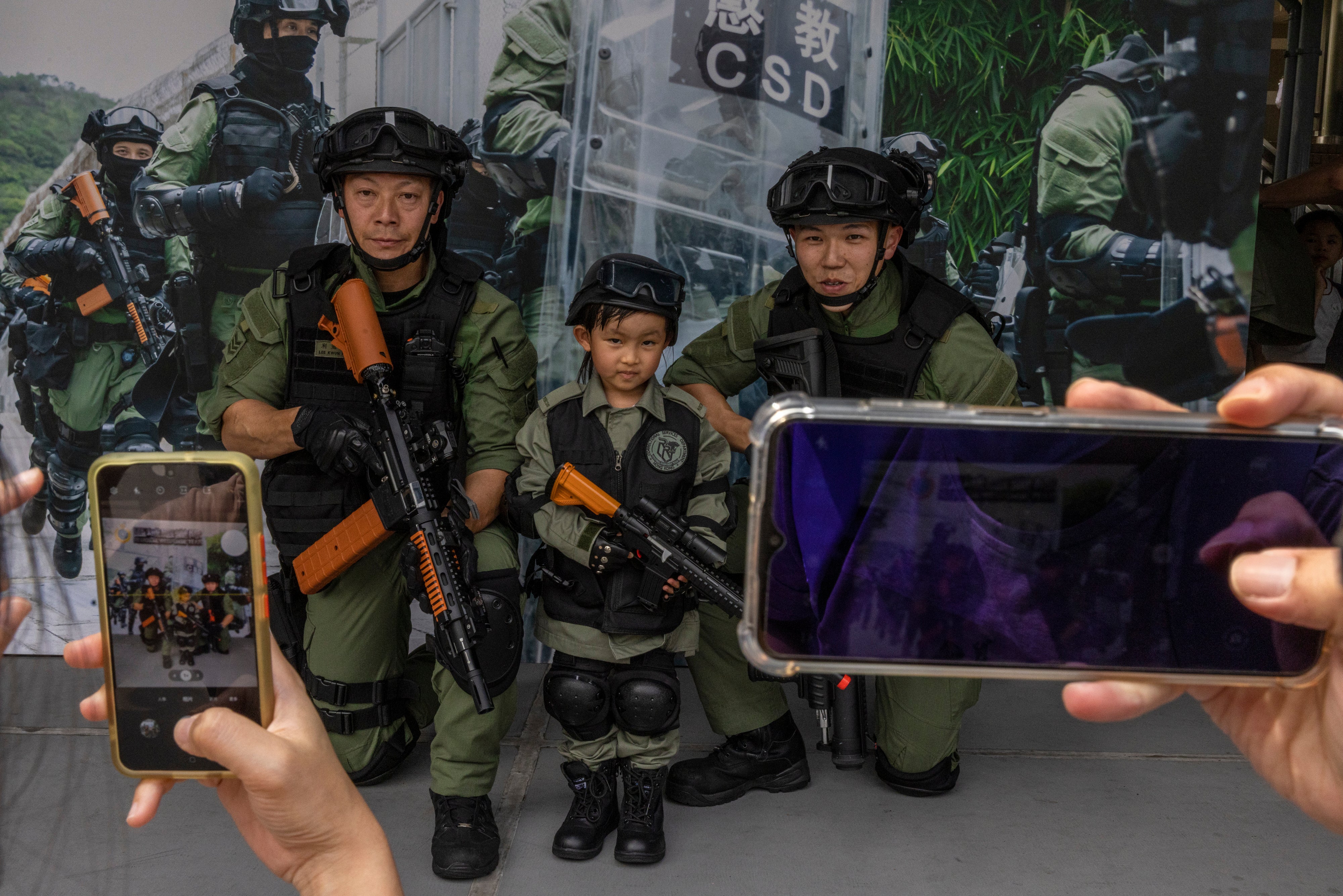 A child poses for a photo at the Hong Kong Correctional Services Academy during the National Security Education Day in Hong Kong, April 15, 2023. 
