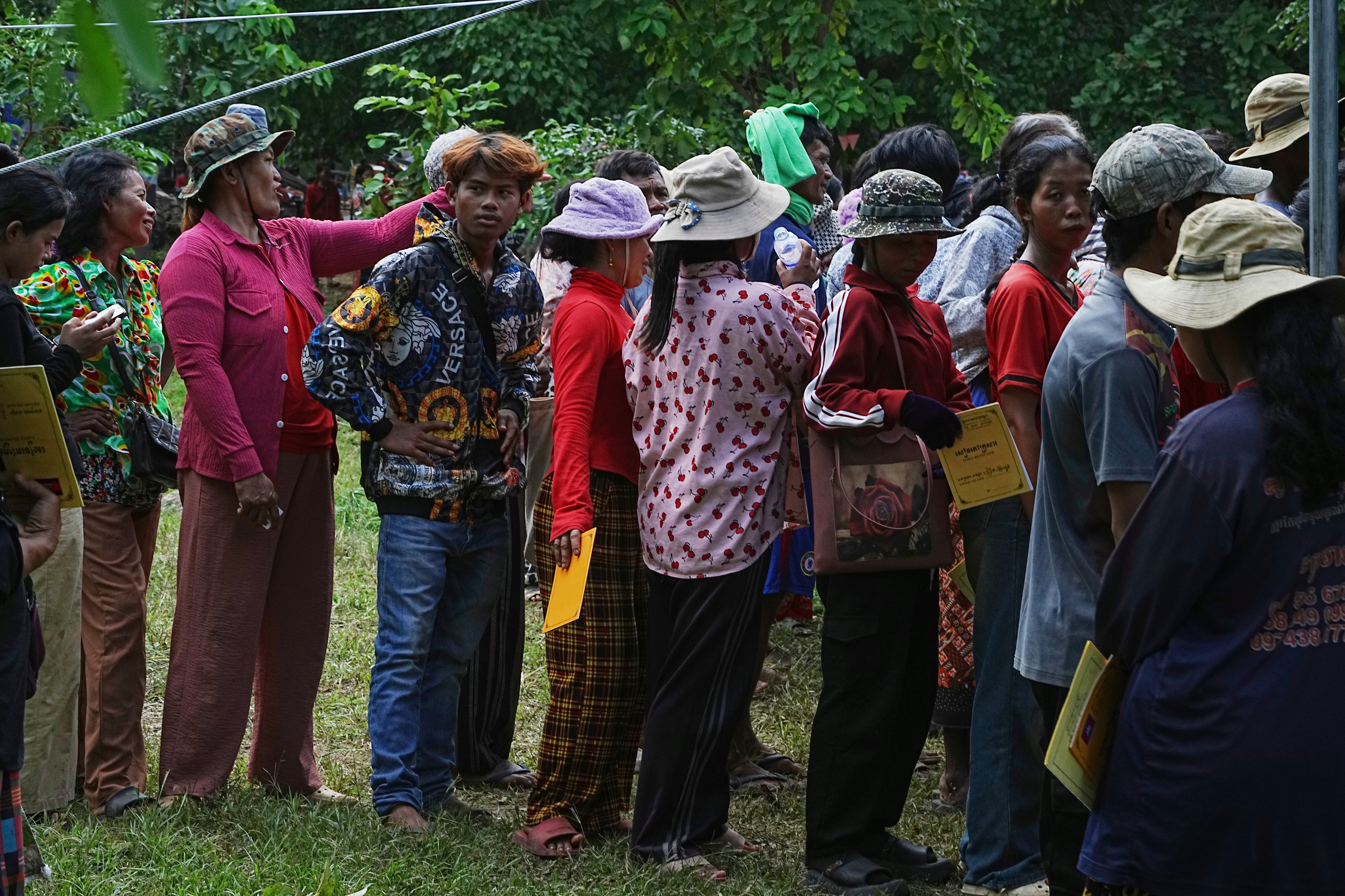 Cambodians who fled Thai-Cambodian border clashes line up to receive assistance in Oddar Meanchey province, Cambodia, July 25, 2025. 