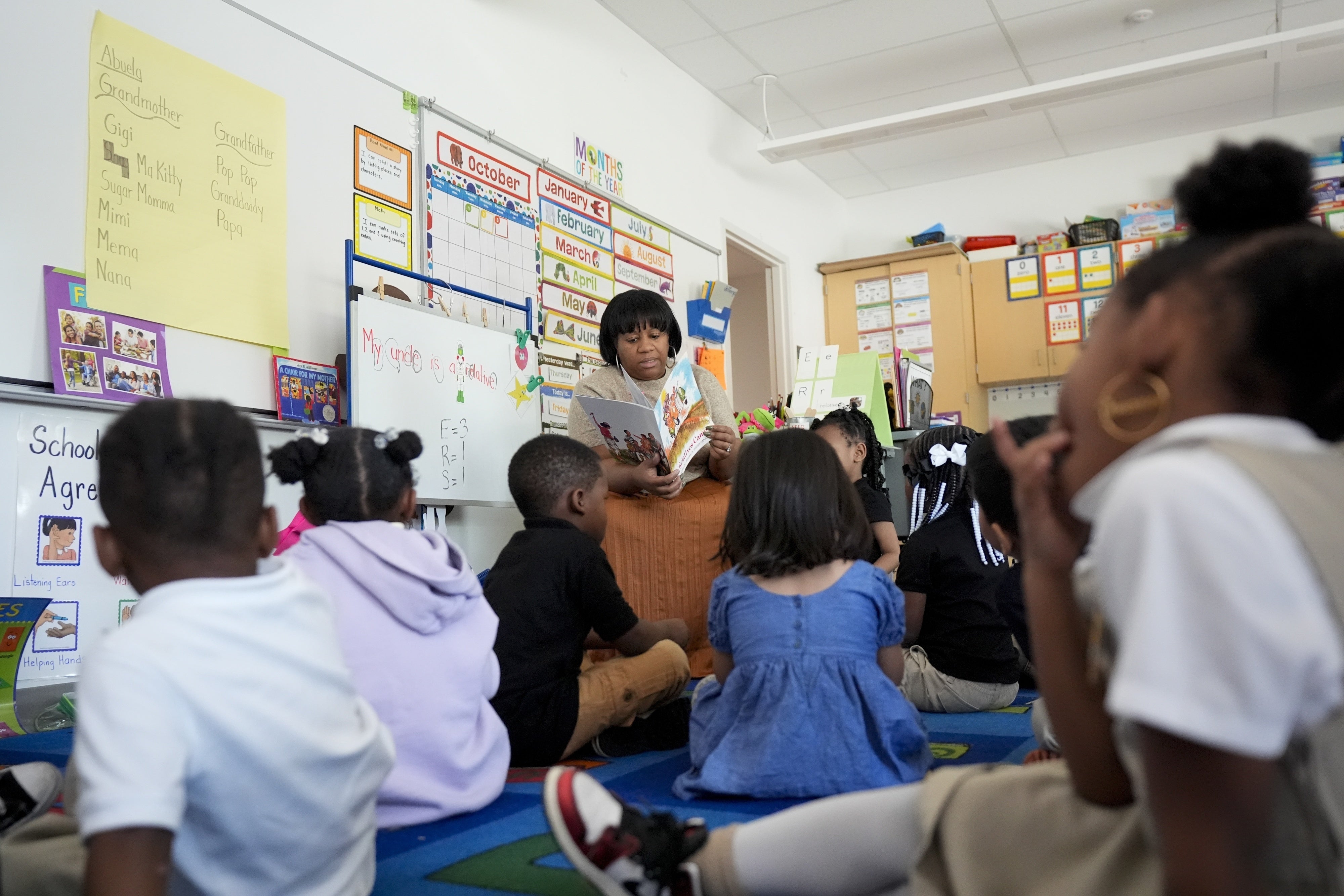 A preschool teacher reads to students at Dorothy I. Height Elementary School in Baltimore, Maryland, US, October 3, 2024.
