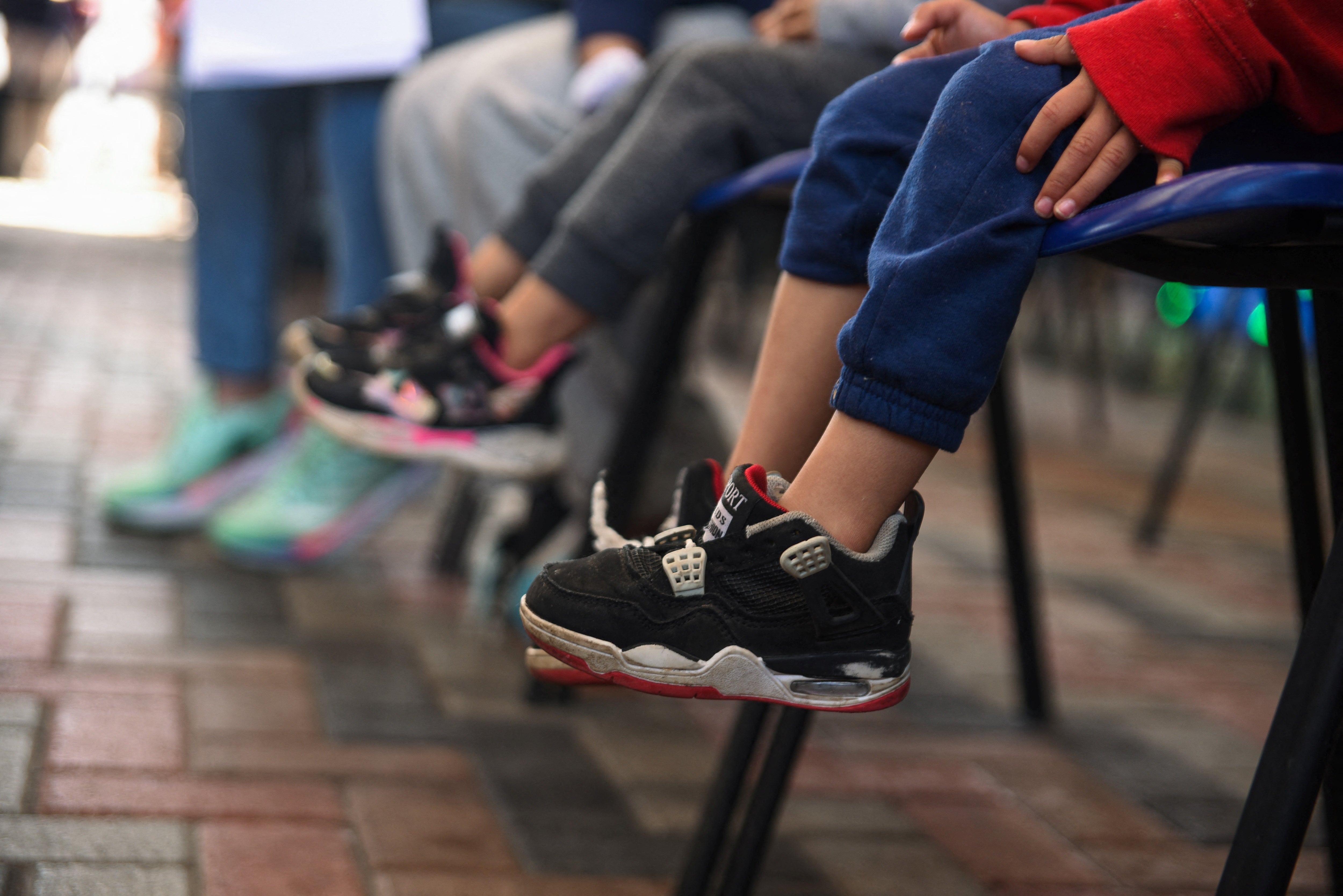 Deported children, along with their parents, sit in a migration office after being processed by staff of the Guatemalan Immigration Institute after arriving on deportation flights from the United States and Mexico, in Guatemala City, Guatemala, January 23, 2024.