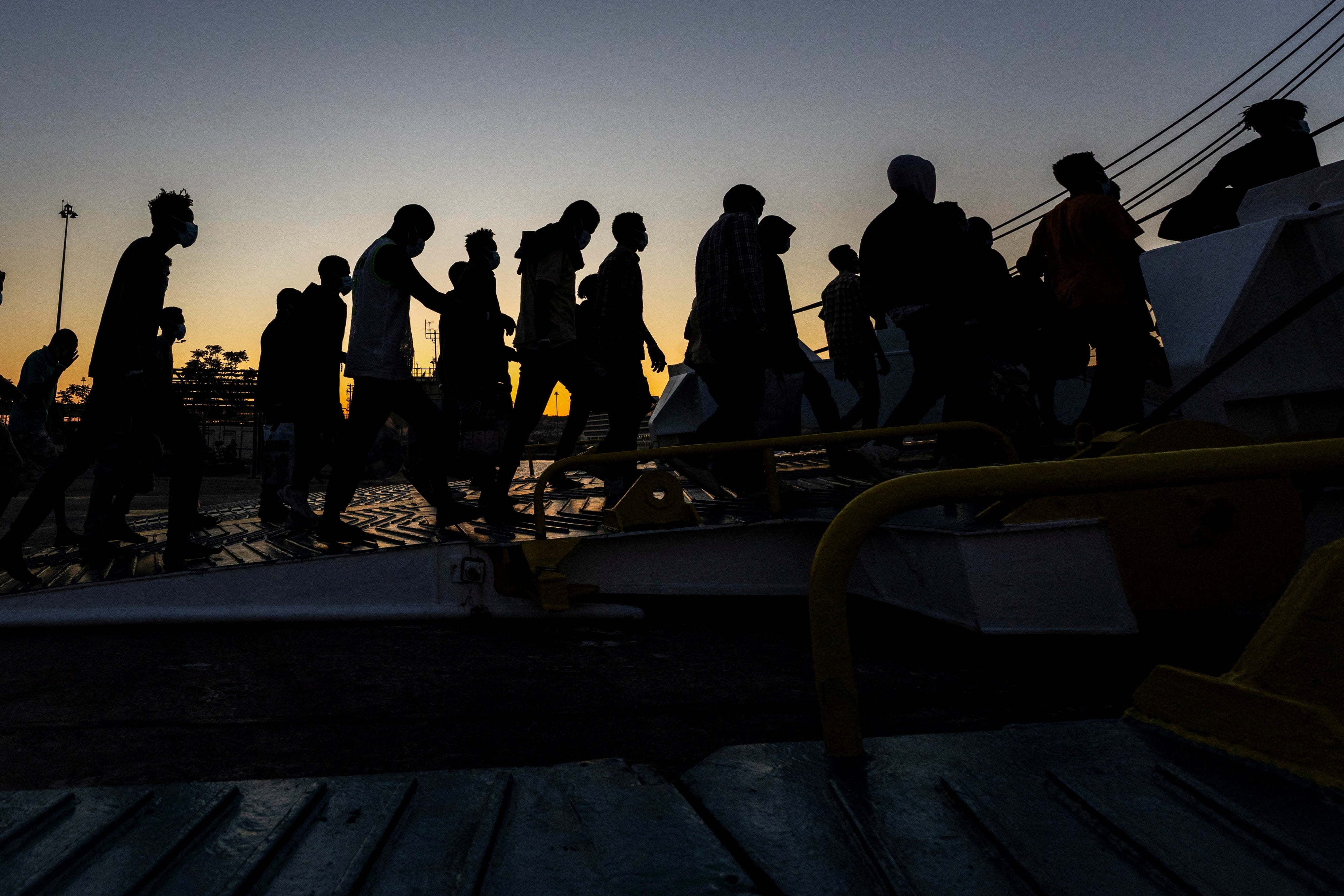 A group of newly-arrived migrants board a ferry in Souda, on the island of Crete, Greece, July 11, 2025.