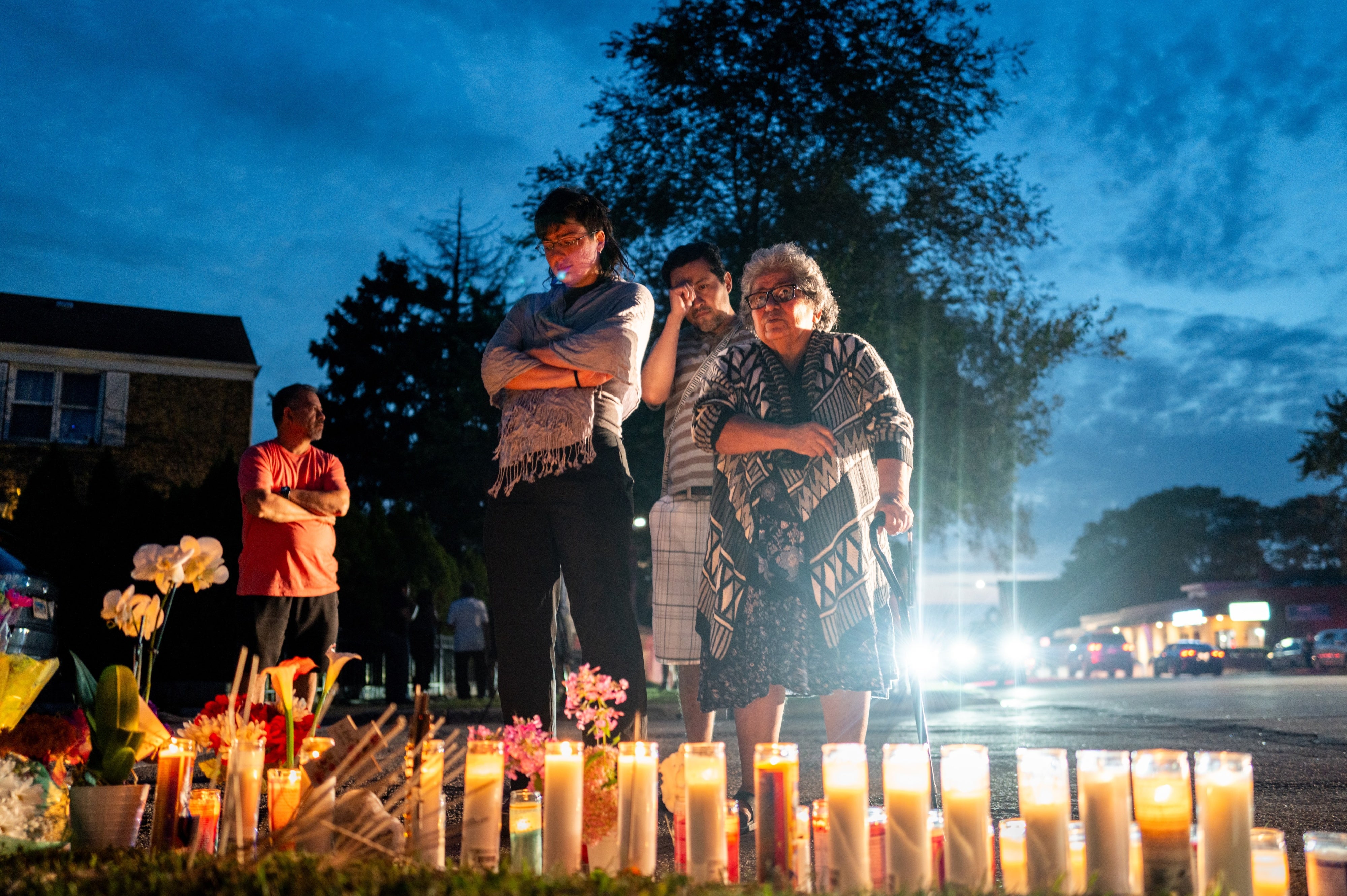 People pay their respects during a demonstration near a small memorial for Silverio Villegas-Gonzalez on September 13, 2025 in Franklin Park, Illinois, US.