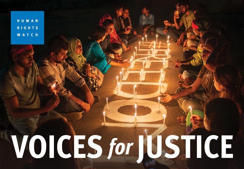 A group of people sitting around candles and the word "freedom".