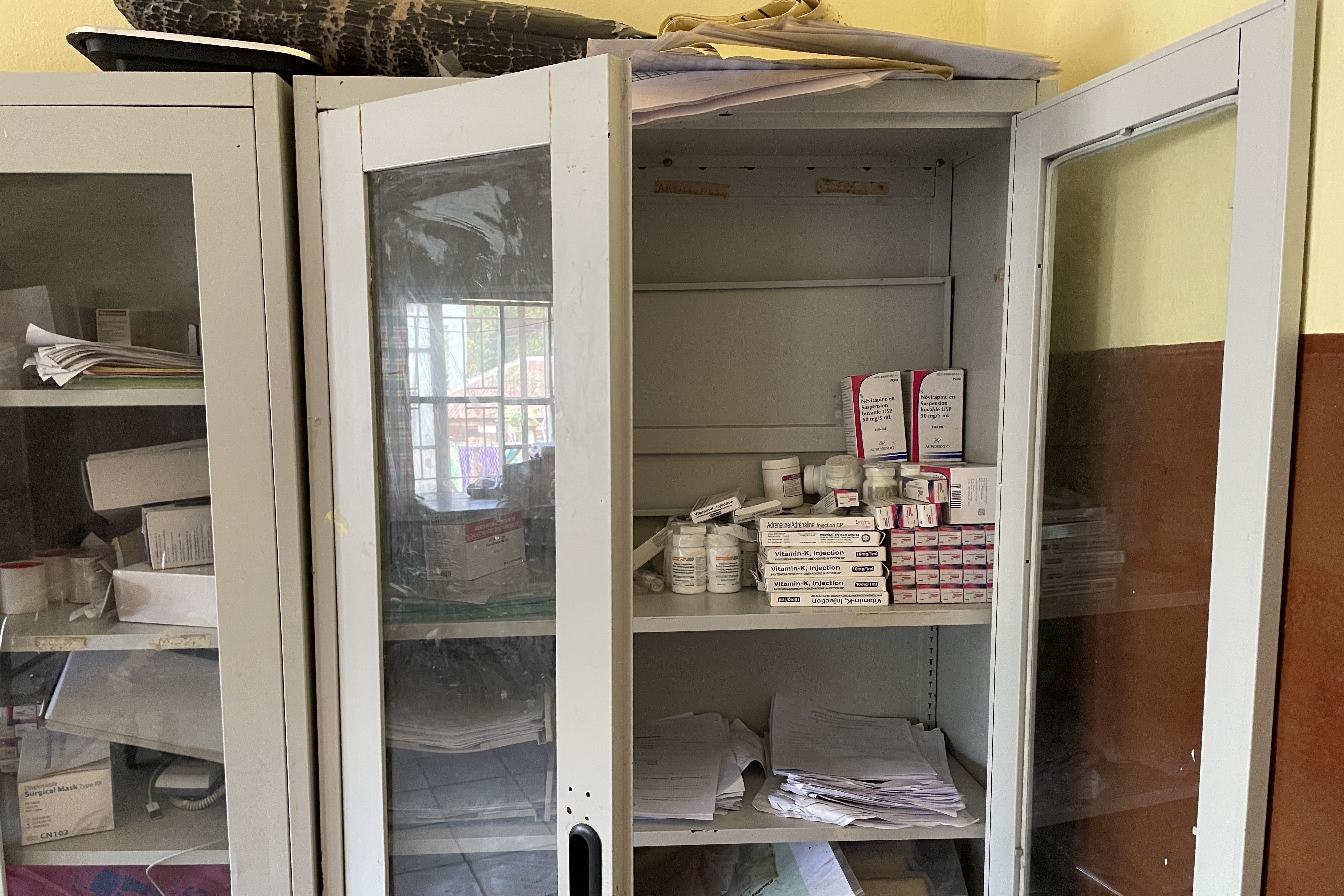 A medicine cupboard with doors unlocked and open
