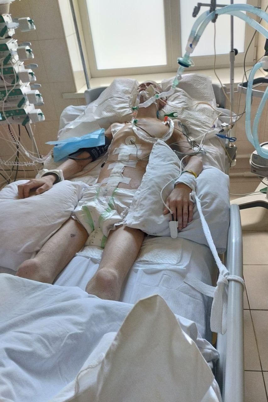 A man lies in a hospital bed