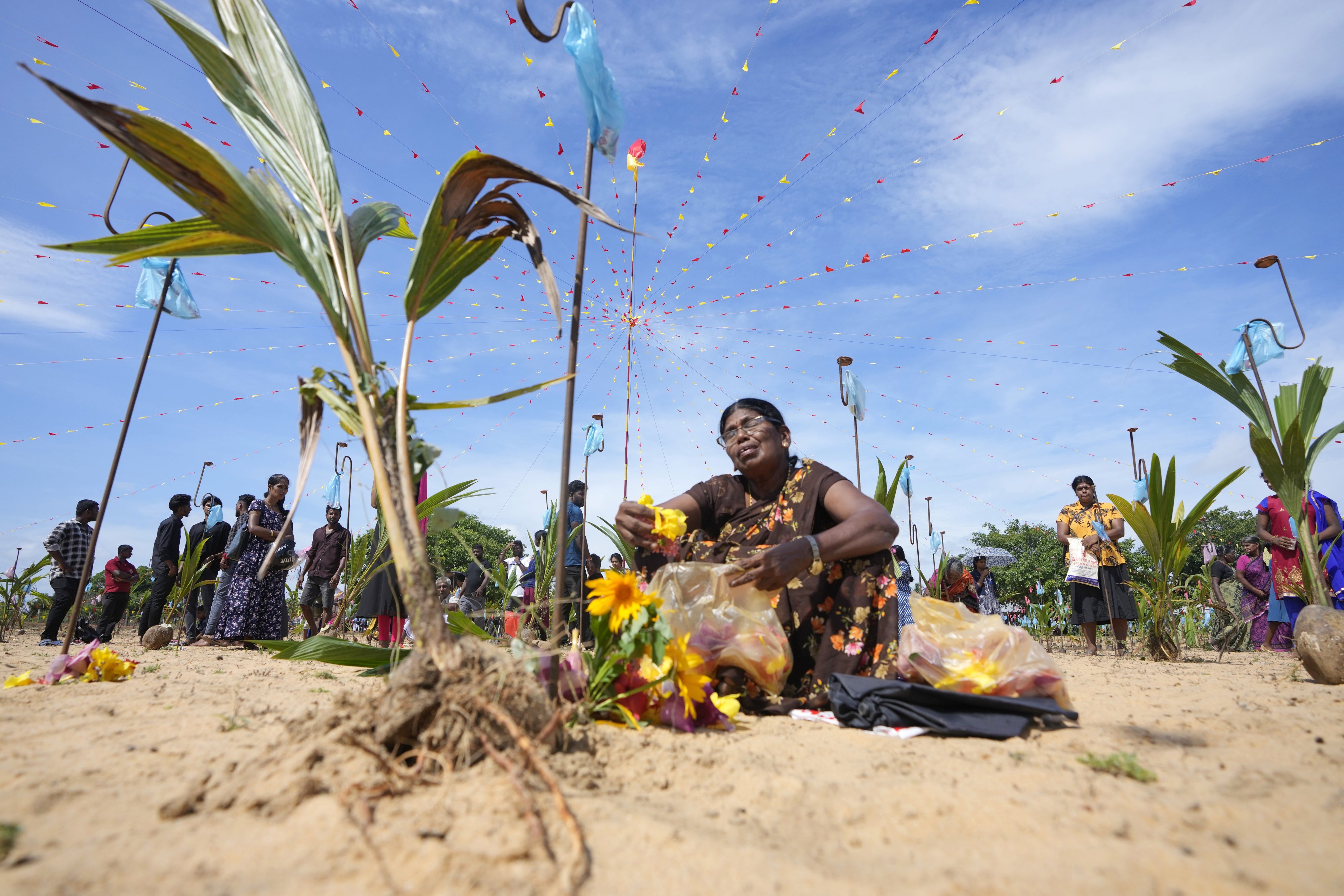 Families mourn victims of Sri Lanka’s 1983-2009 civil war on the beach at Mullivaikal where the final battle took place, May 17, 2024. 