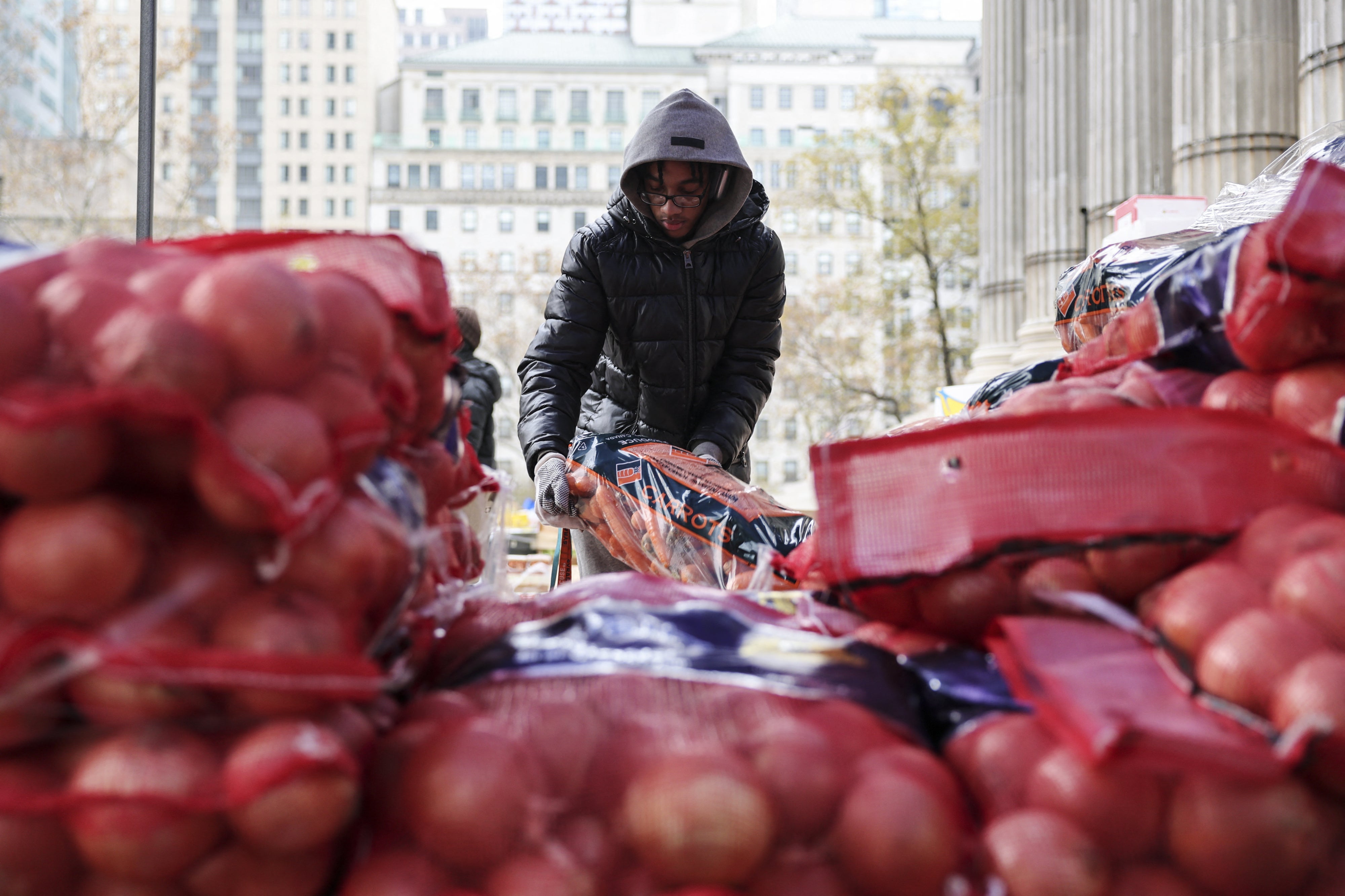 A volunteer at a food distribution event outside of Brooklyn Borough Hall in New York City, November 21, 2025. 