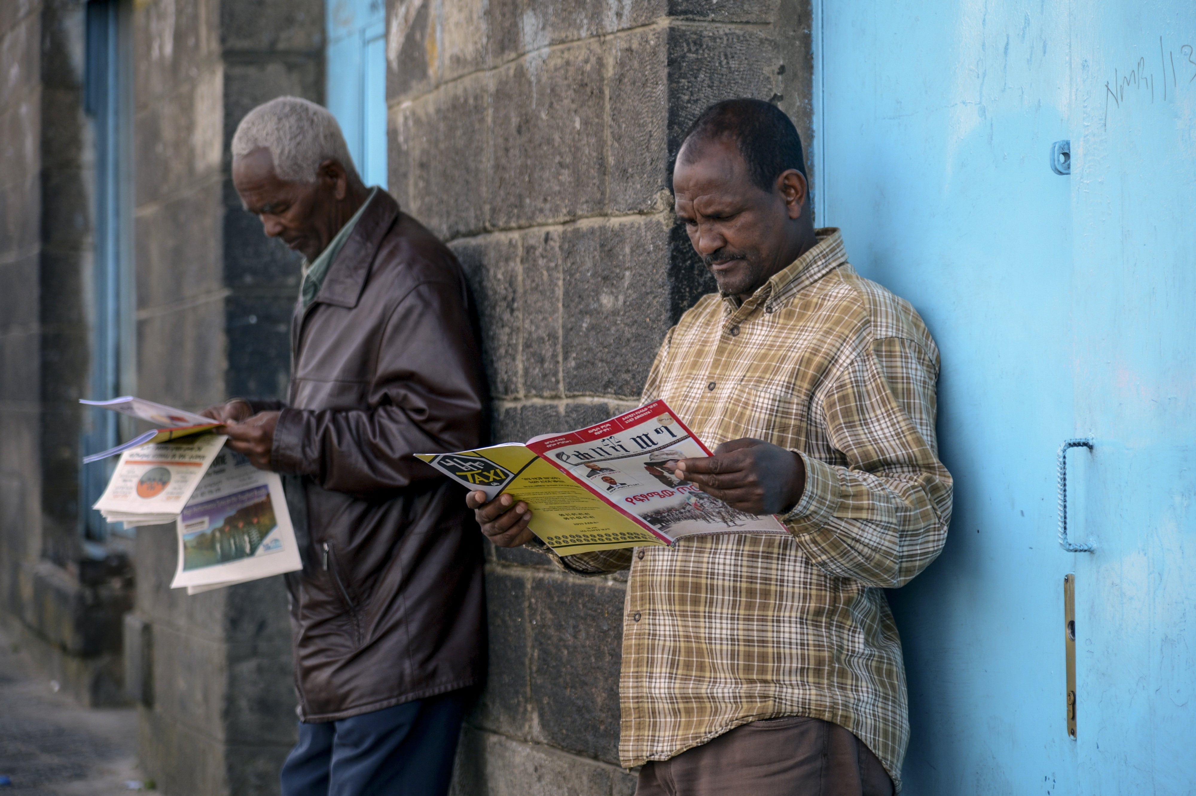 People read newspapers and magazines on a street in Addis Ababa, Ethiopia, November 7, 2020.