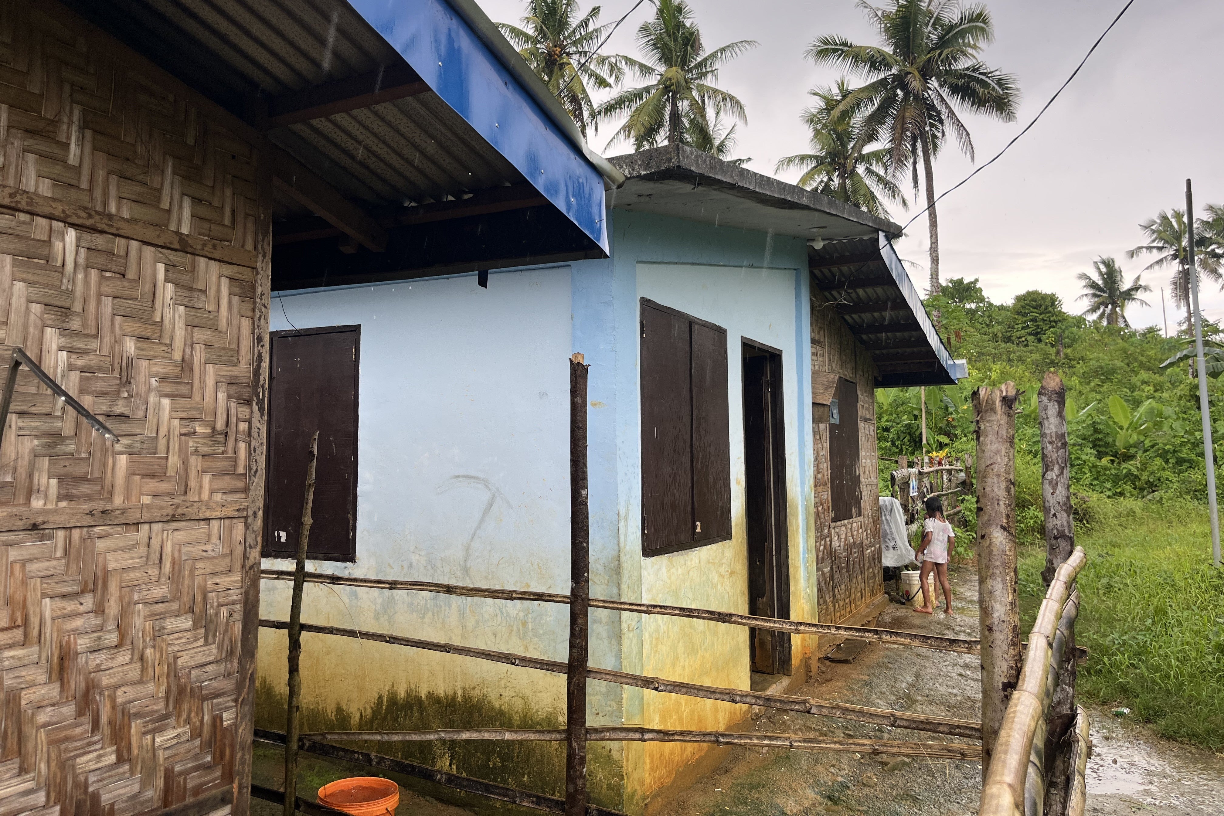 Water stains mark the exterior walls of homes after flooding