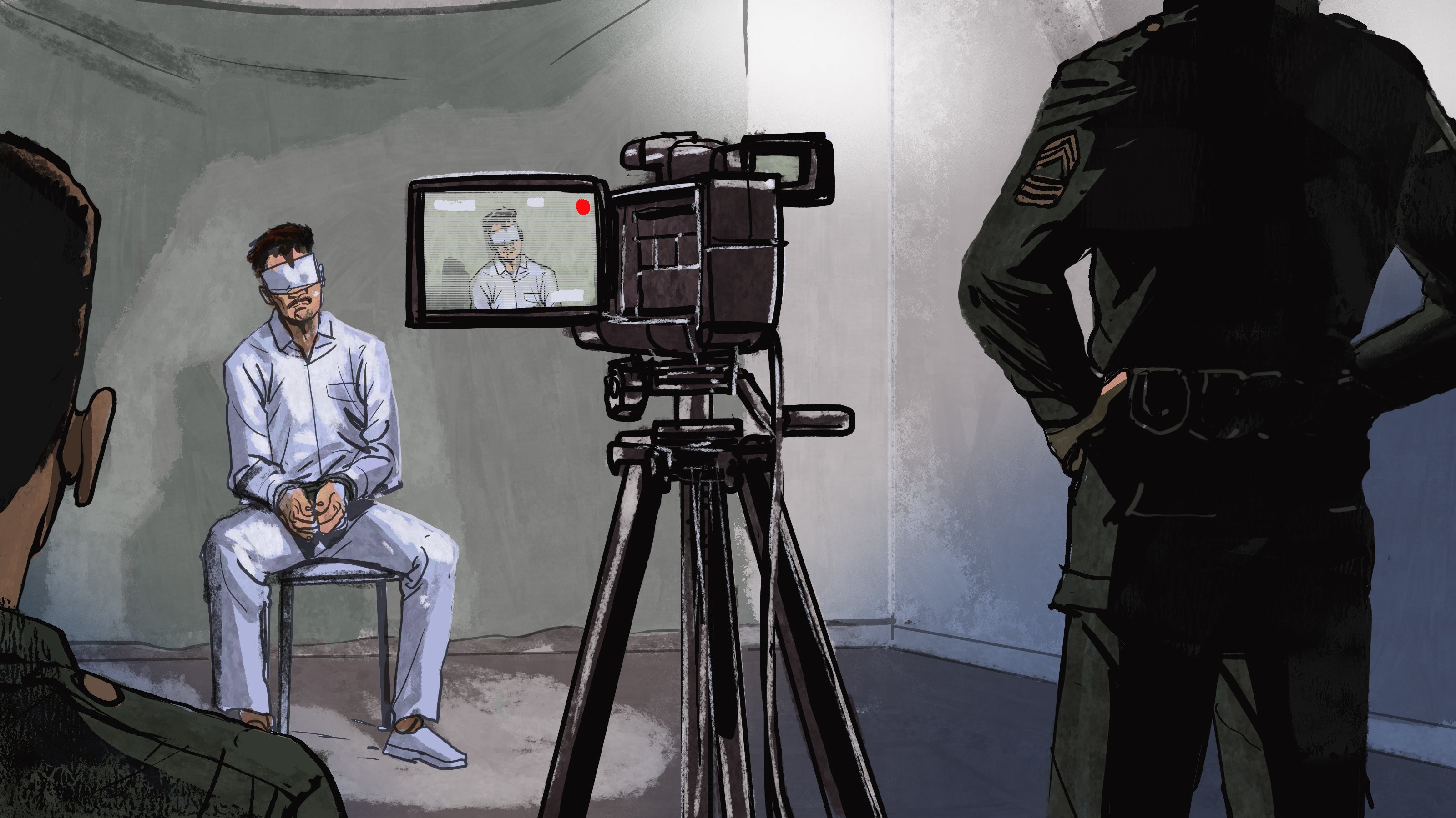 A blindfolded man sits in front of a camera on a tripod