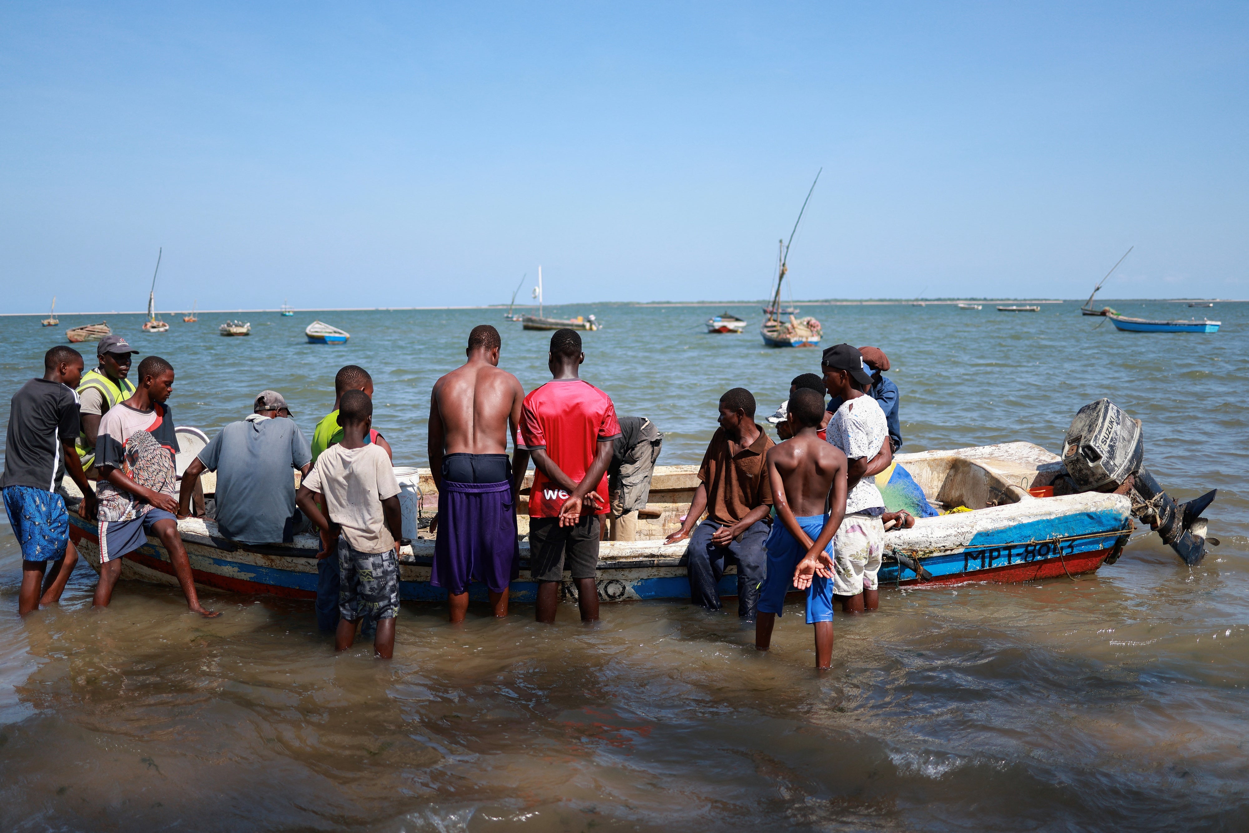 Fishermen sort their catch before carrying it to shore near the Costa do Sol fish market in Maputo, Mozambique, January 10, 2025.