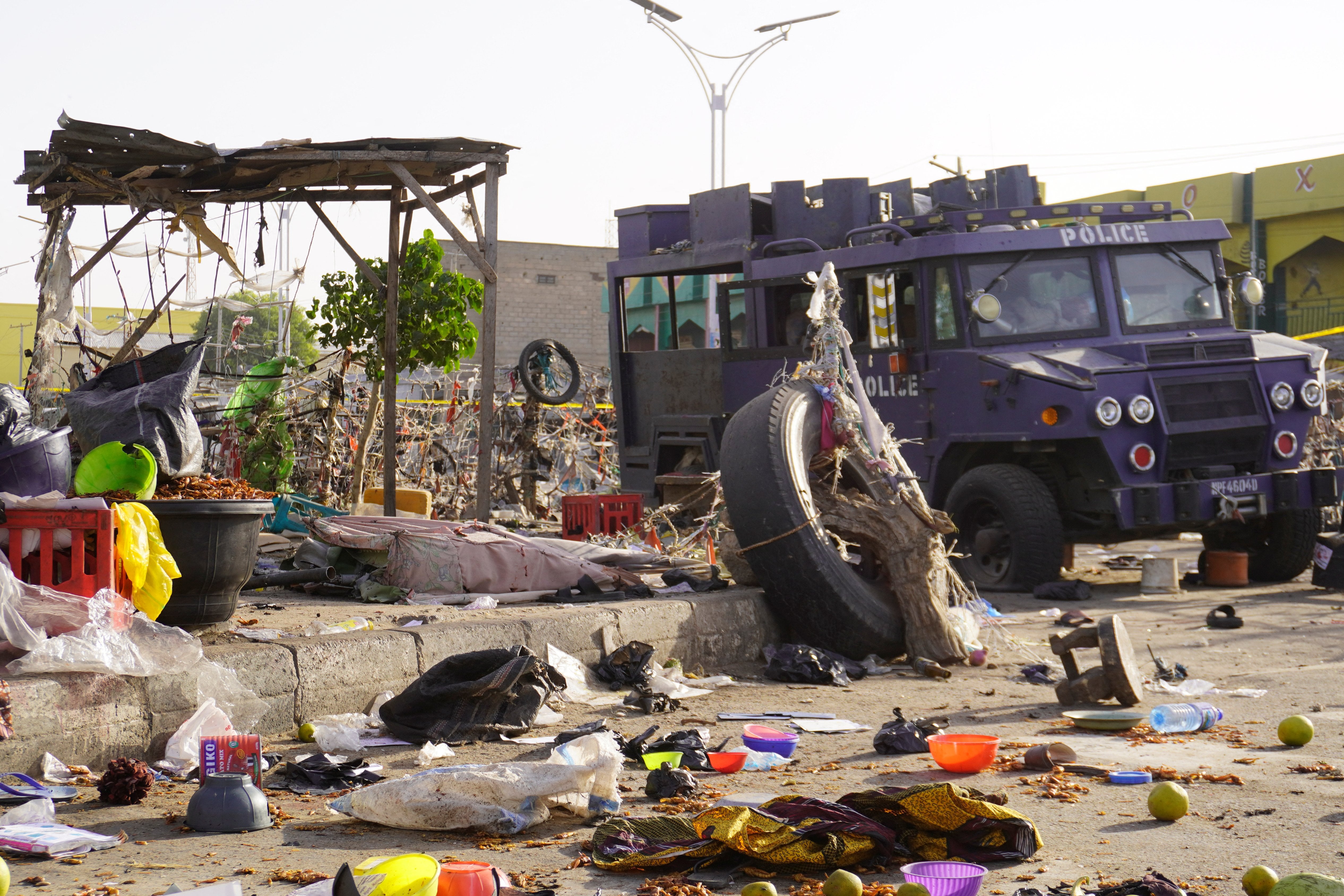 An armored police vehicle at a market in Maiduguri, Nigeria amid debris