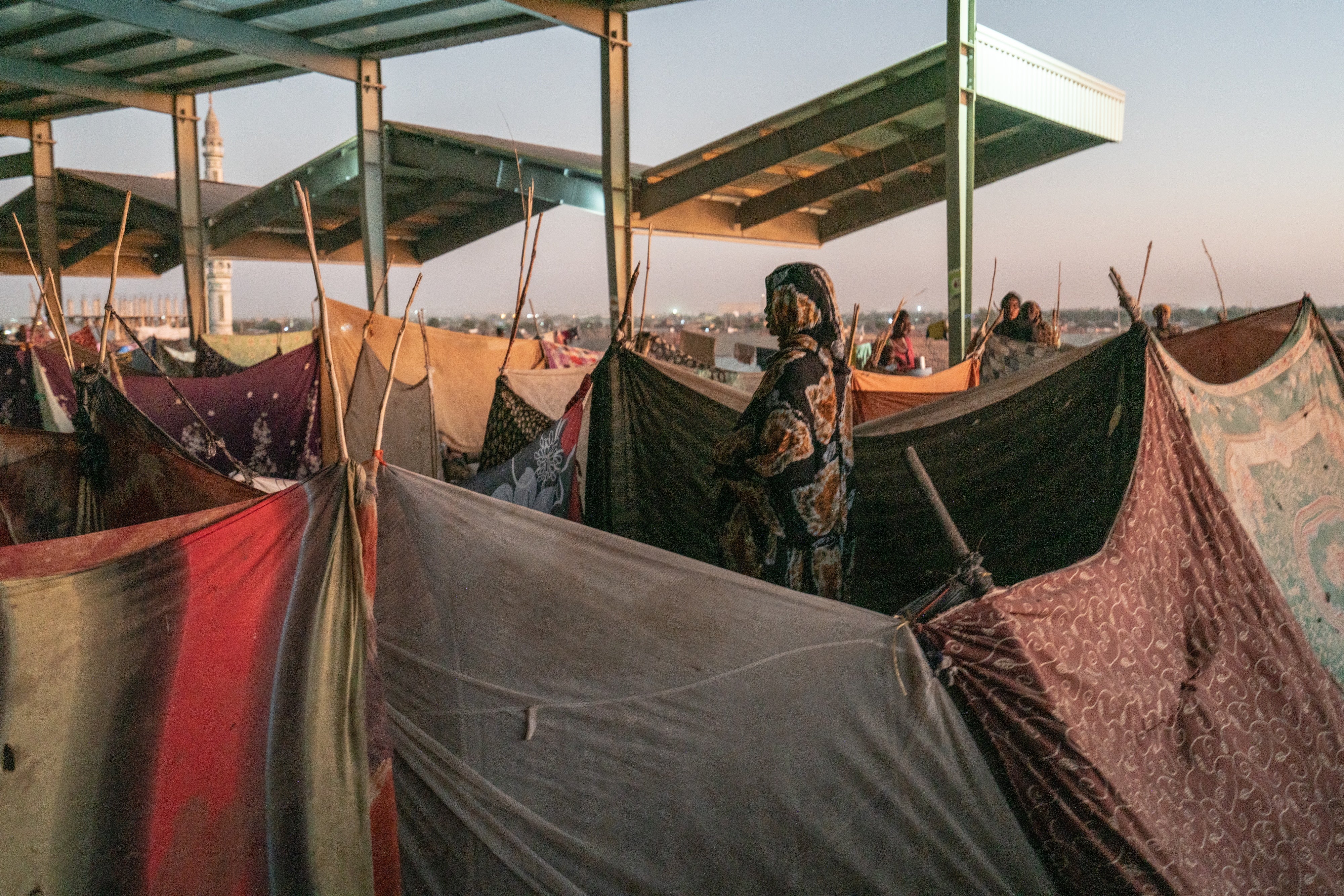 A former bus station hosts internally displaced people who arrived in Gedarefduring during a wave of mass displacement from the Sinjar/Sannar region south of Khartoum, Sudan, July 2024. 