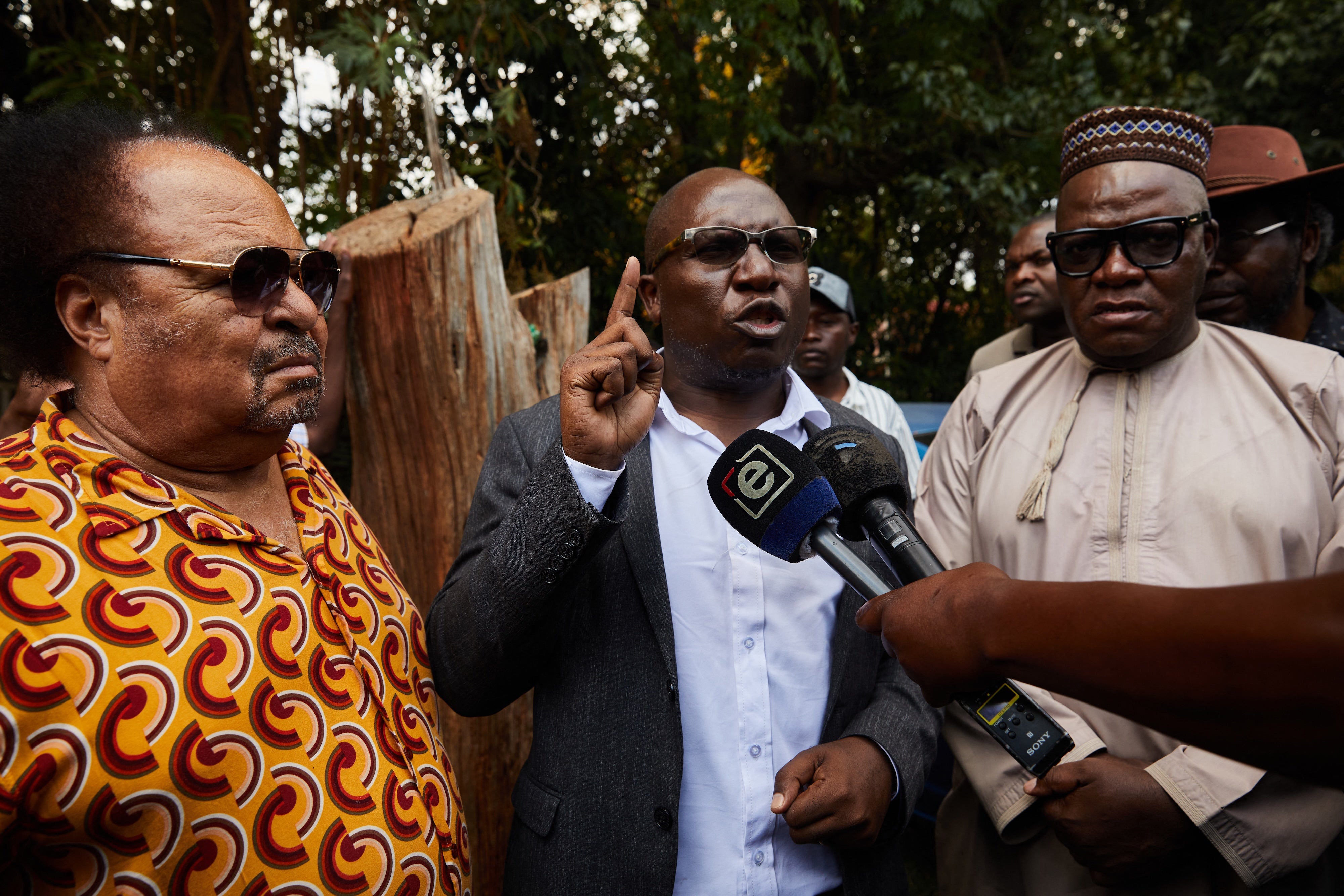 SAPES Trust director Ibbo Mandaza (L) listens to Jacob Ngarivhume (C) and Tendai Biti (R) speaking to the media at the Trust in Harare, Zimbabwe on October 28, 2025.