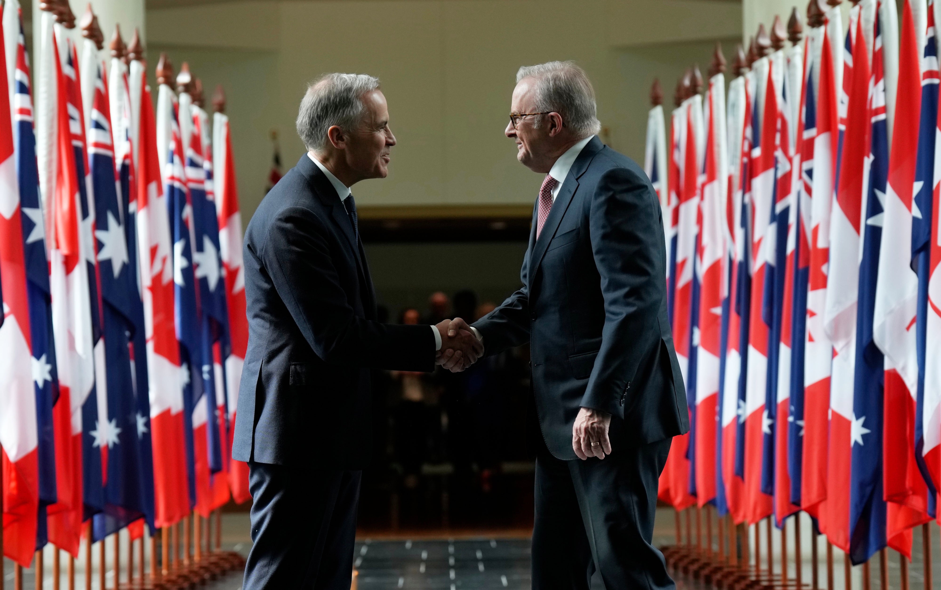 Canada's Prime Minister Mark Carney (left) and Australian Prime Minister Anthony Albanese as they leave Parliament following an address, in Canberra, Australia, March 5, 2026.