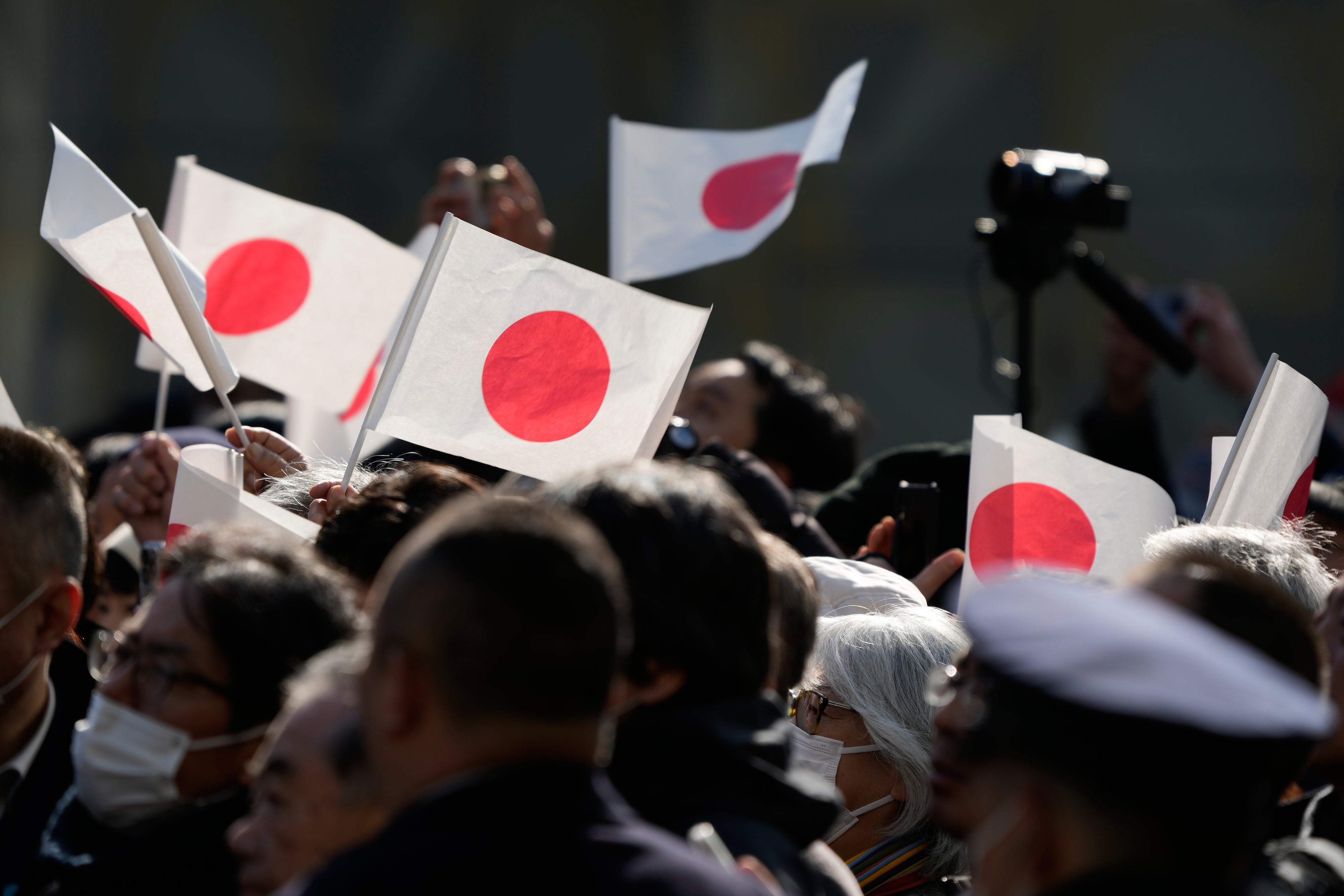 People wave Japanese flag in Tokyo, January 27, 2026.