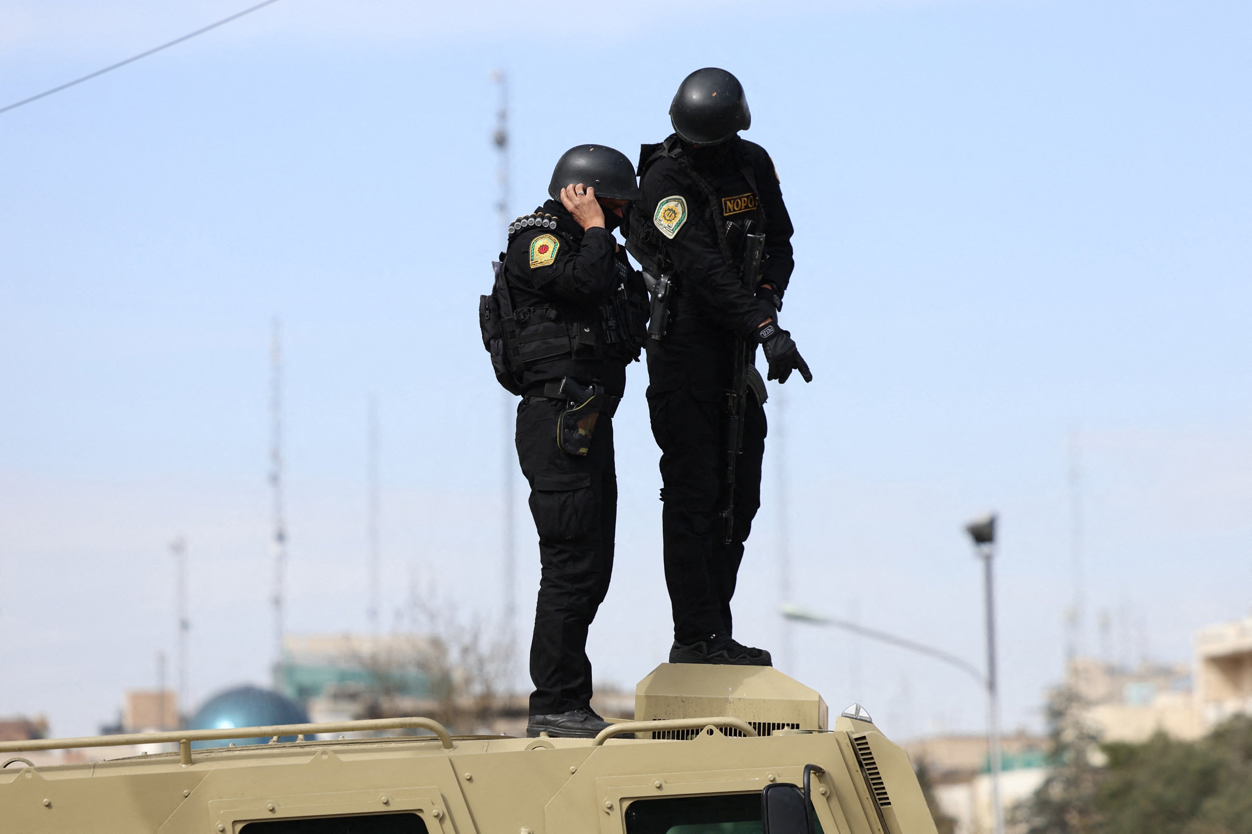 Iranian security forces stand guard on top of an armored vehicle in Tehran on March 21, 2026.