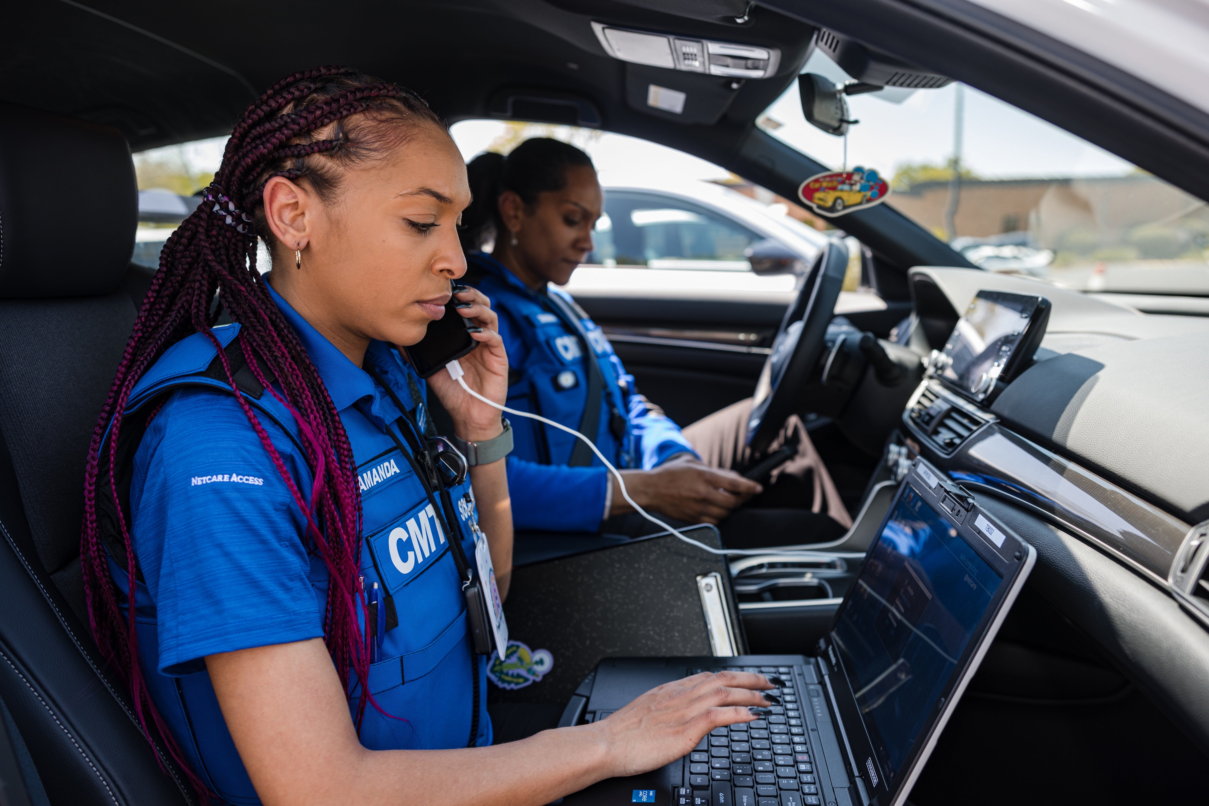 Community mobile team reviews material in a car