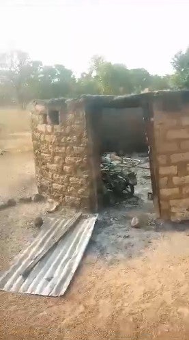 Screengrab of a video shared by a witness showing a burned hut