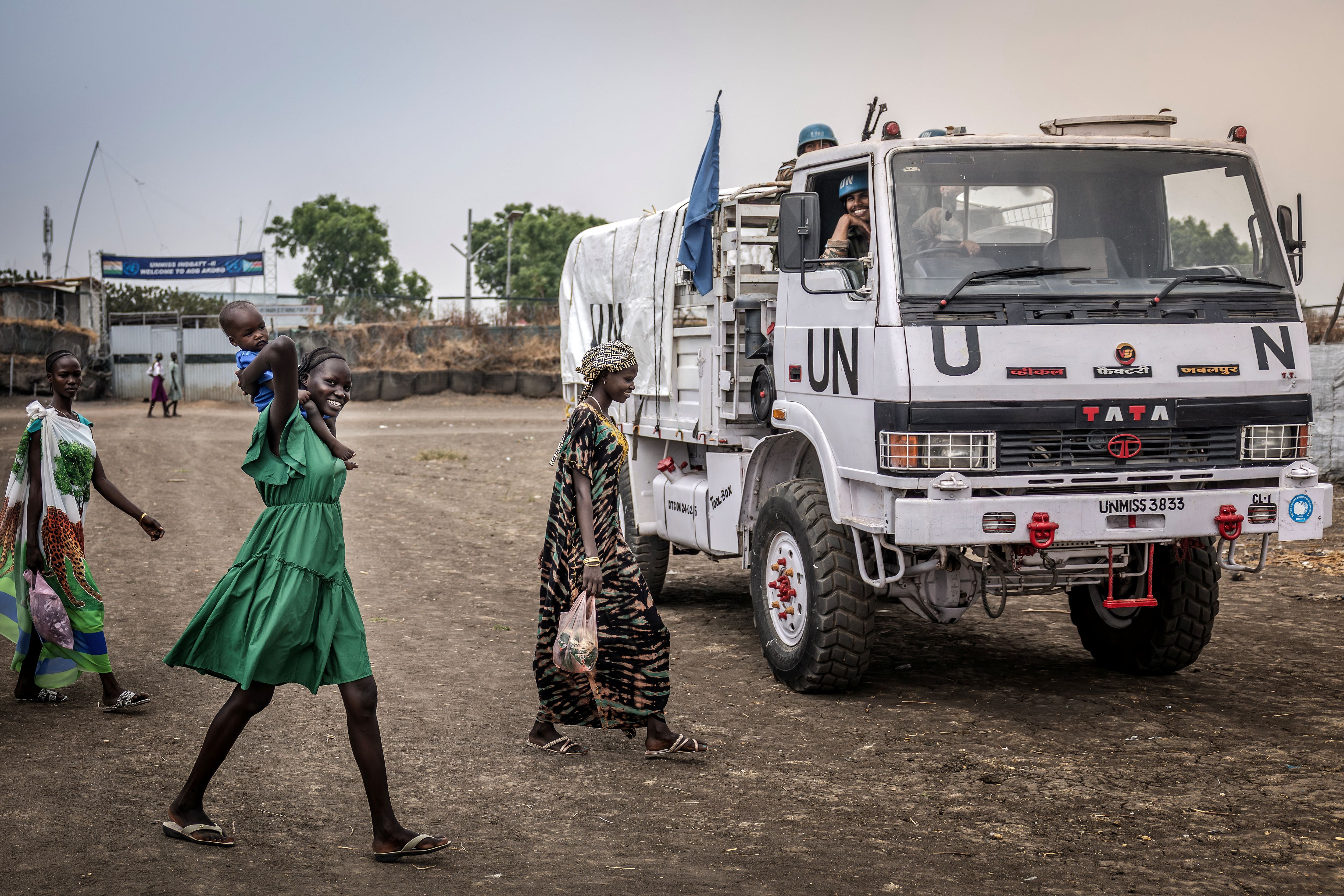 Residents react as they walk past a patrol truck operated by Indian peacekeepers serving with the United Nations Mission in South Sudan (UNMISS) in the strategic town of Akobo, Jonglei State, on February 12, 2026.