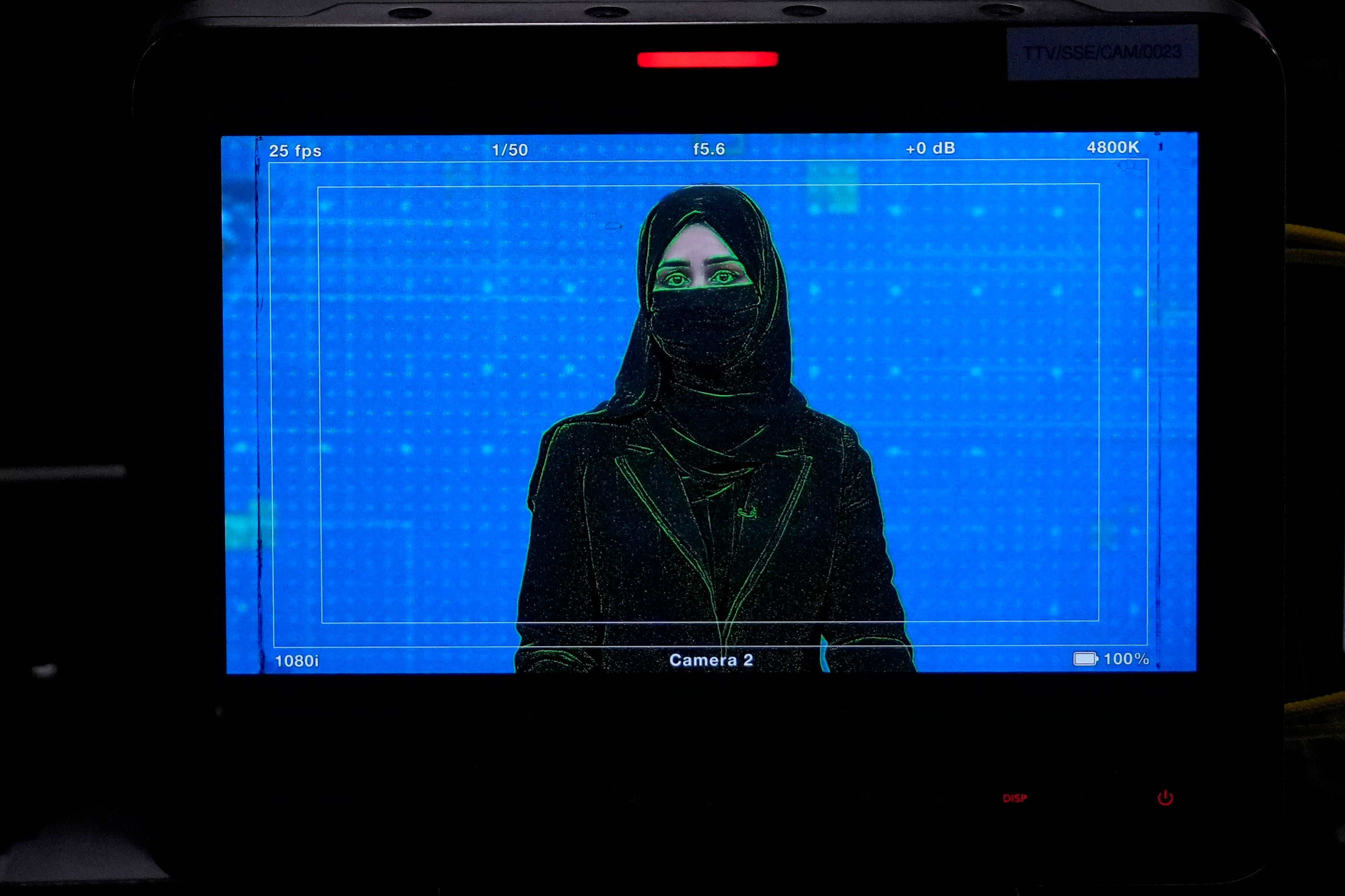 TV anchor Khatereh Ahmadi  wearing a face covering as she reads the news in Kabul, Afghanistan, May 22, 2022.