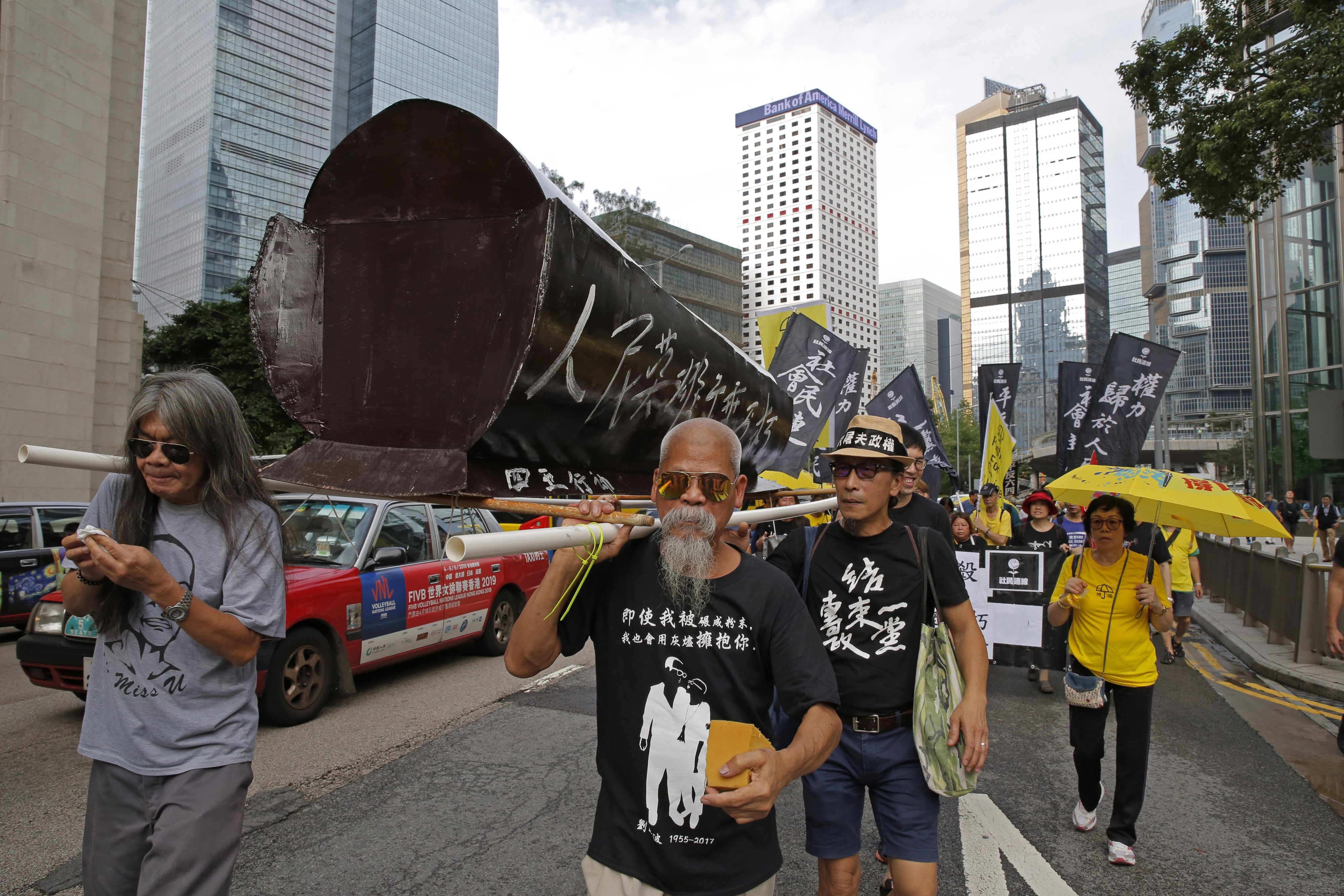 Koo Sze-yiu carries a coffin that reads, “The people’s heroes, they shall remain forever immortal" at a protest in Hong Kong, May 26, 2019