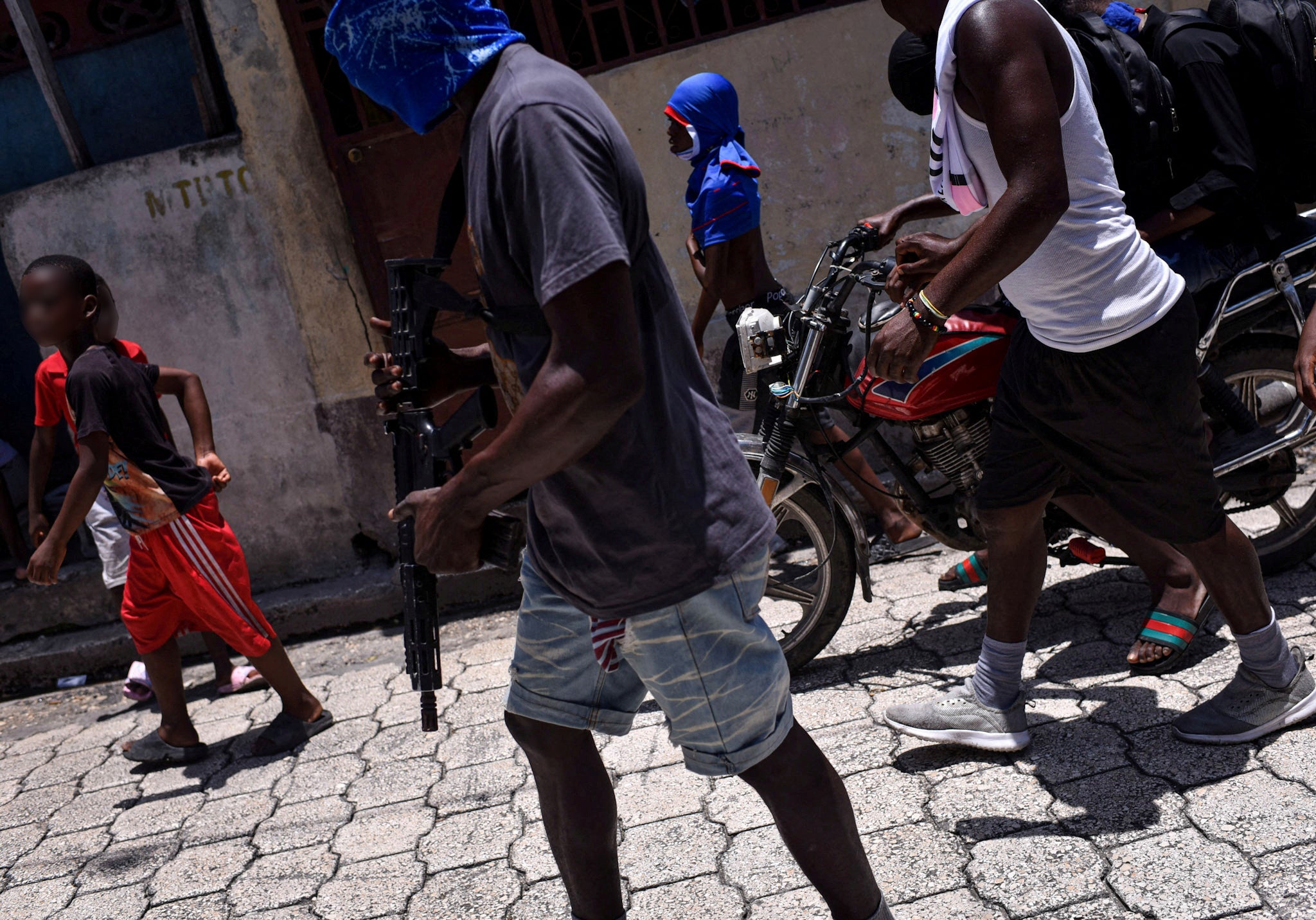 Children accompany criminal group members in a march in the Delmas neighborhood of Port-au-Prince, Haiti, May 10, 2024.
