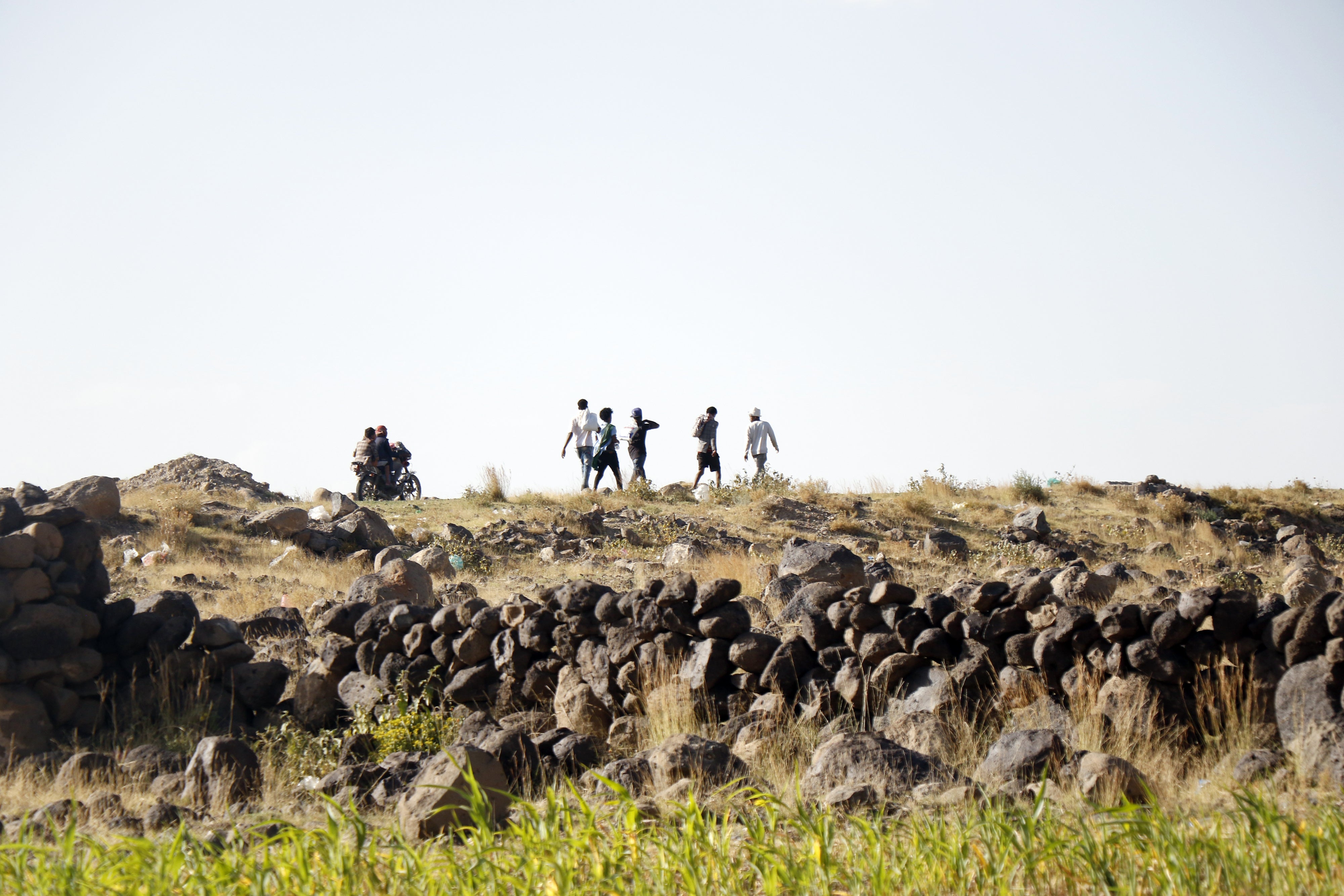 Ethiopian migrants seeking asylum or a better life in Gulf States, walk along a highway to Saadah province to cross into Saudi Arabia, on August 23, 2023 on the outskirts of Sana'a, Yemen.