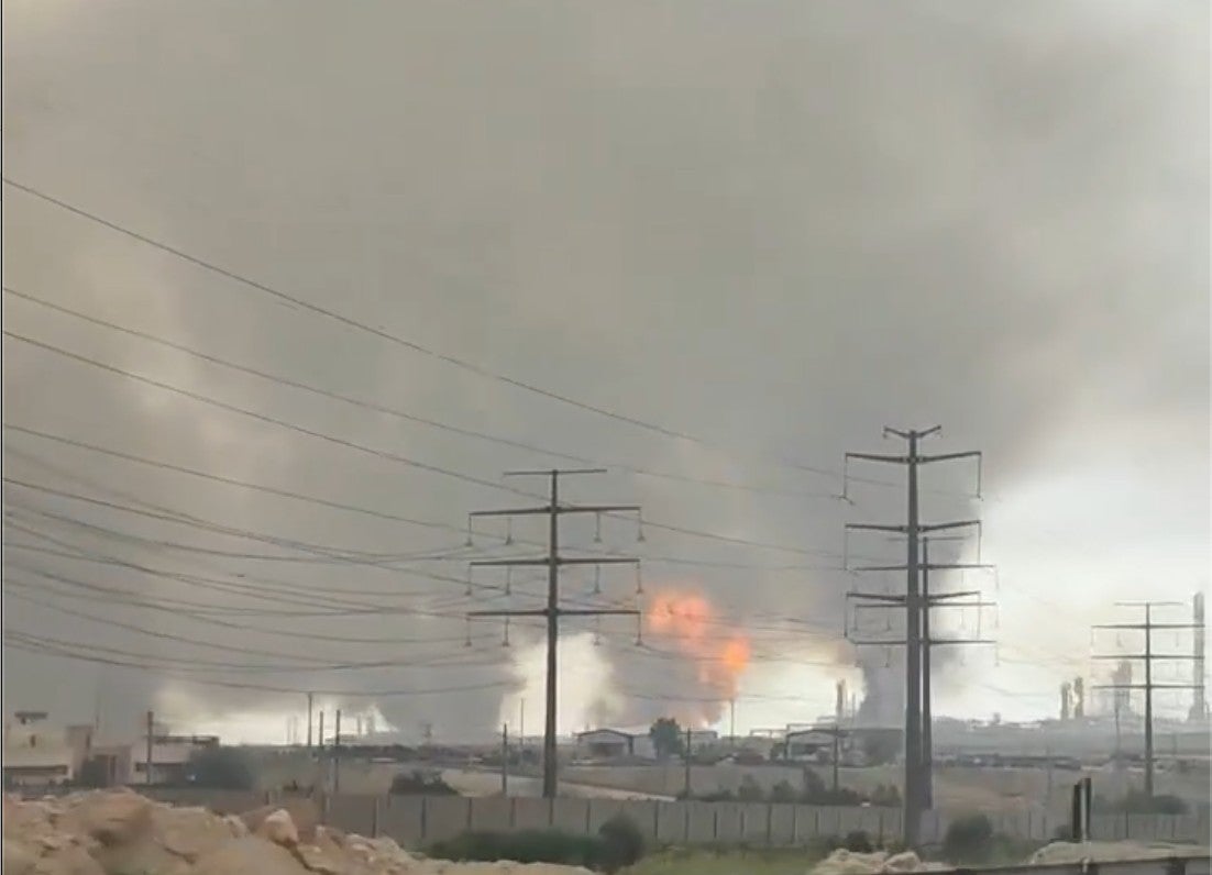Une image extraite d'une vidéo filmée depuis un véhicule sur la route 96, dans le sud de l’Iran, le 18 mars 2026, suite à une frappe israélienne contre le gisement gazier de South Pars. On y voit de très épais nuages de fumée suite aux incendies provoqués, notamment celui de la quatrième raffinerie. Vidéo publiée par Vahid Online (https://x.com/Vahid/status/2034333984503529778), géolocalisée par FactNameh (https://x.com/factnameh/status/2034415274430988685/photo/1), corroborée par Human Rights Watch.