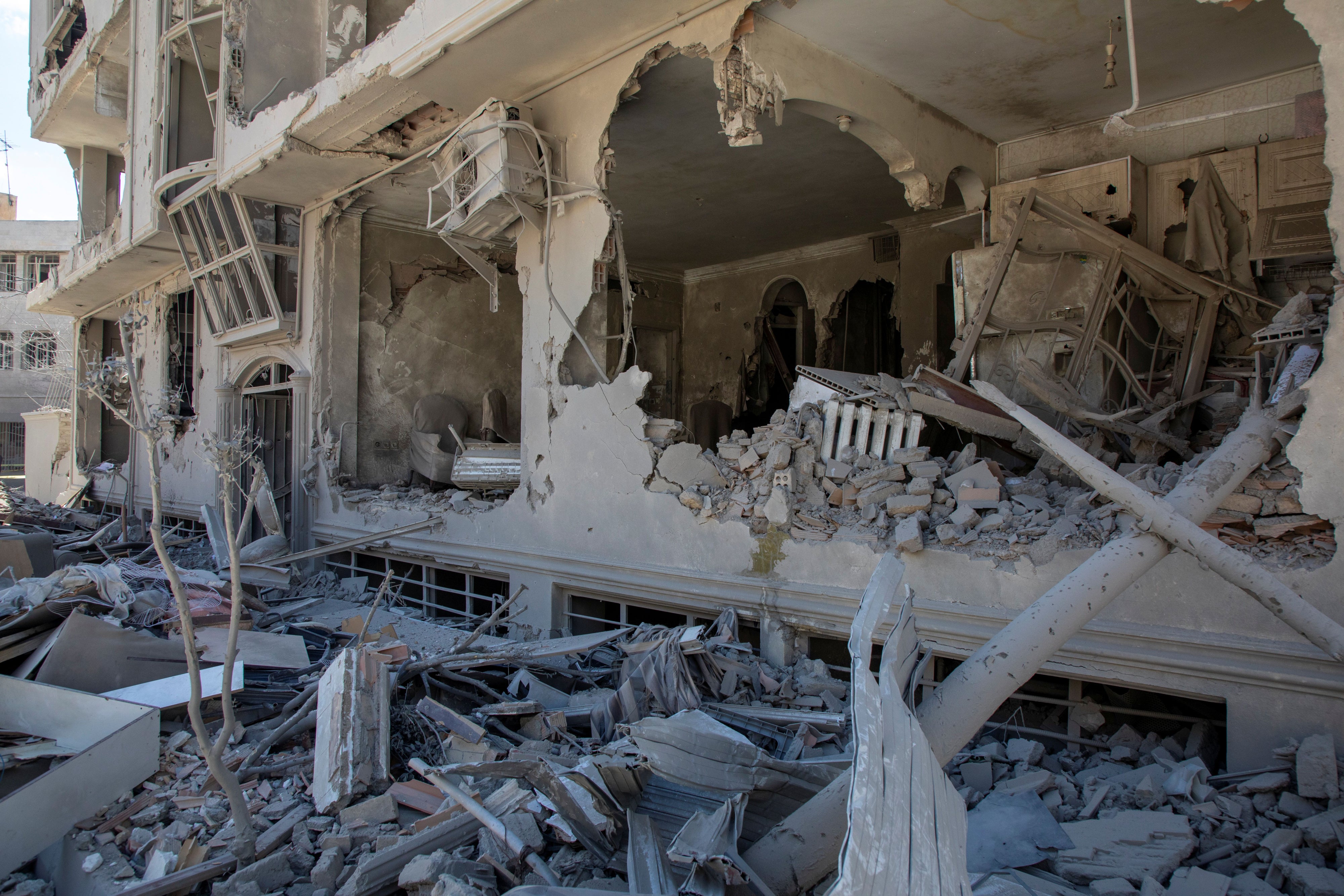 Debris tumbles from a residential building hit in an airstrike  on March 30, 2026 in Tehran, Iran. 