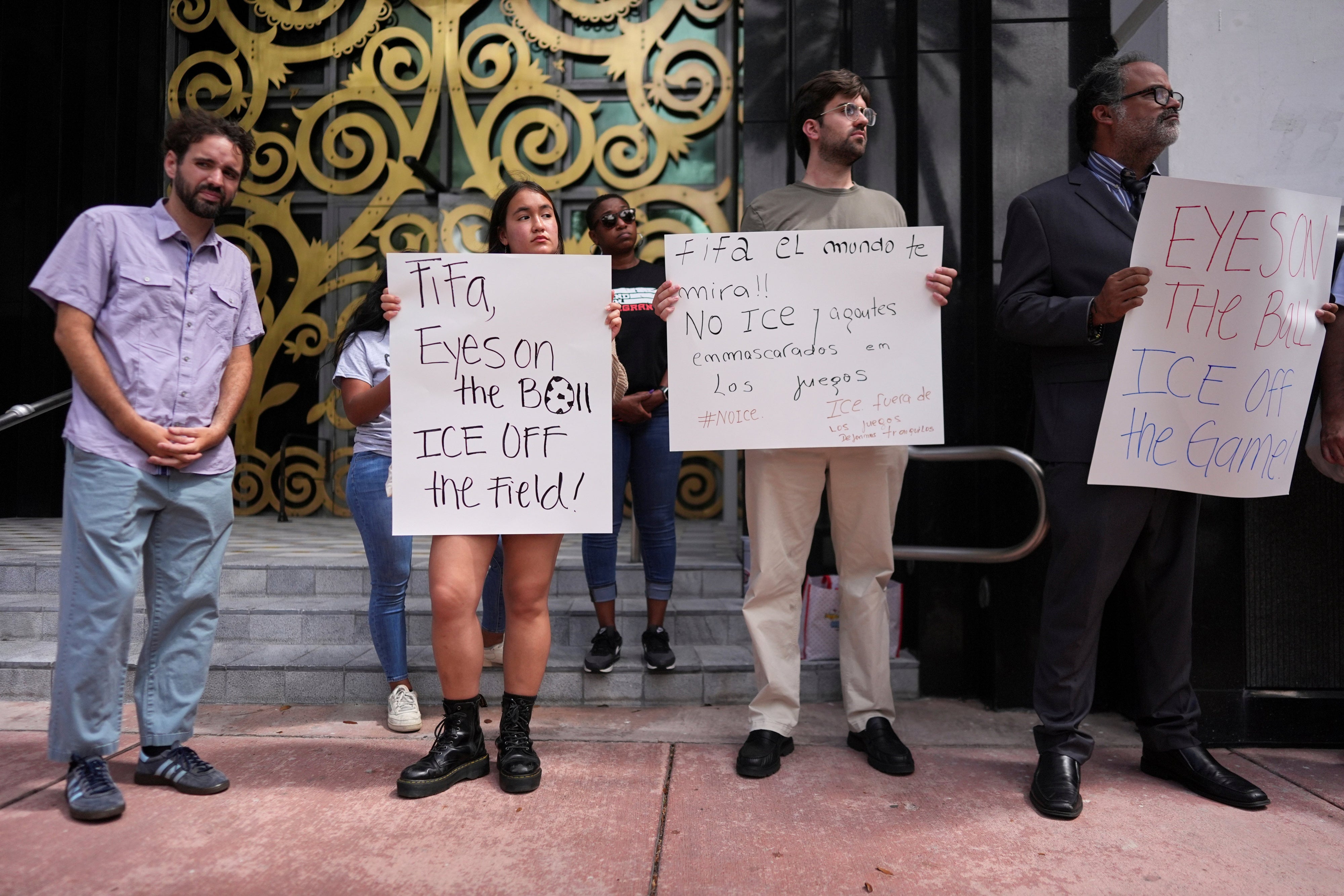 Protestors holding anti-ICE signs