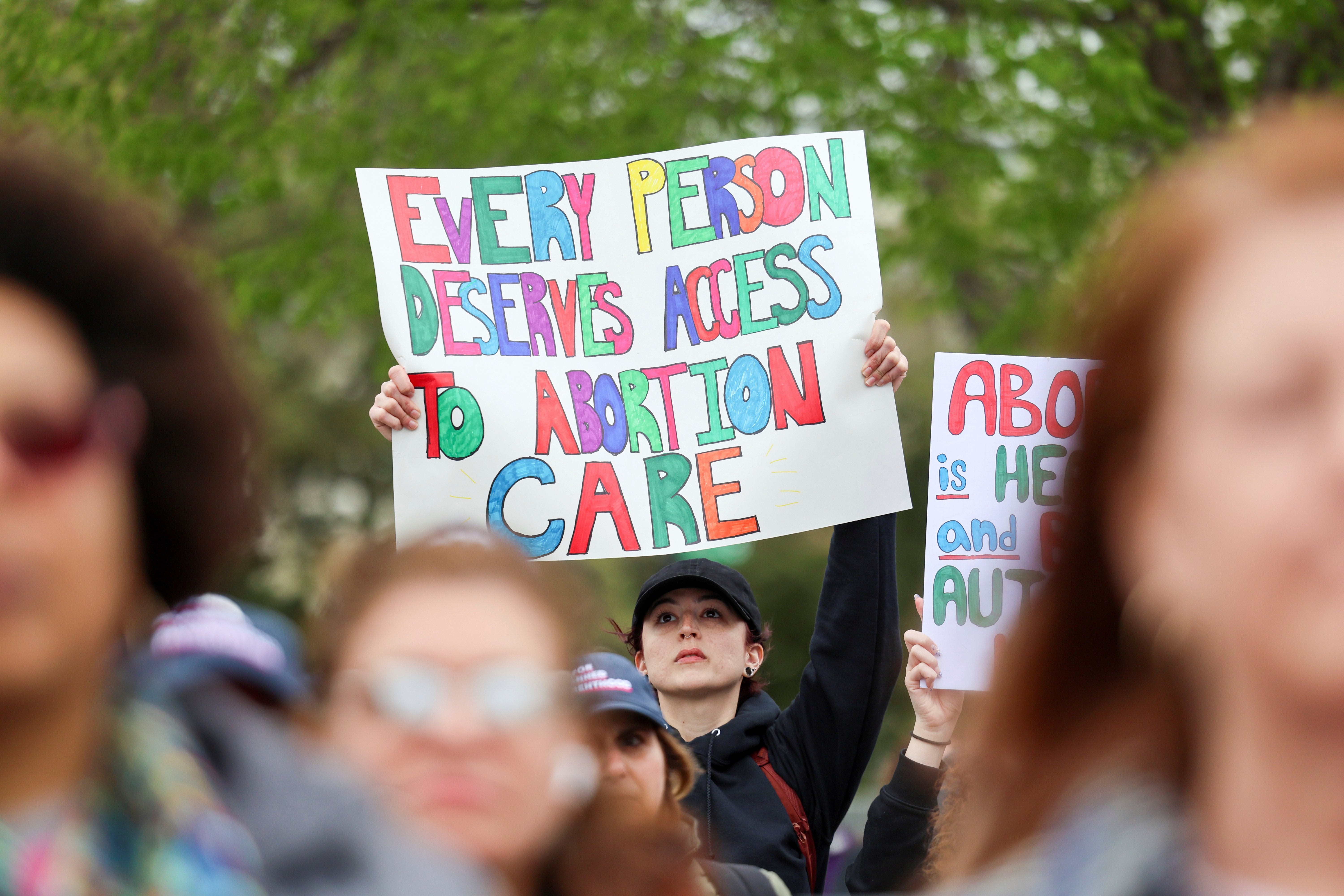 A supporter of Planned Parenthood holds a placard at a rally