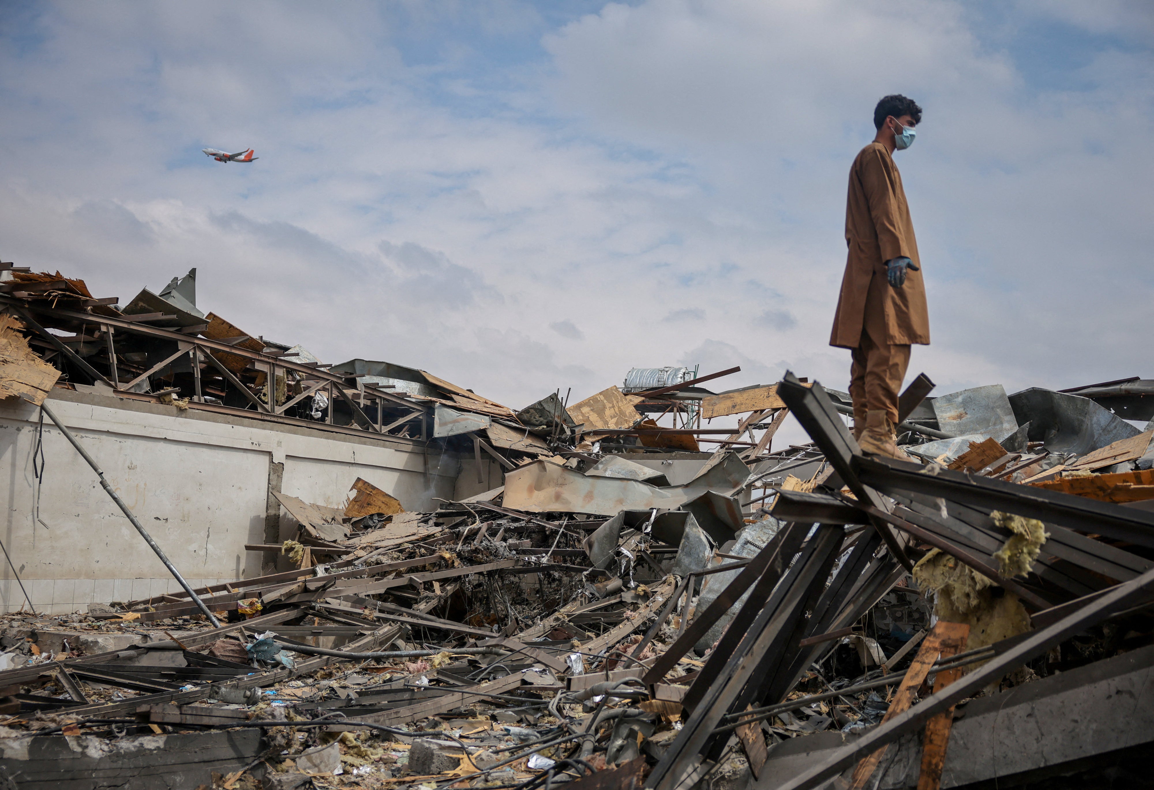 A man stands on the debris at the site of a drug rehabilitation hospital destroyed in what the Taliban said was a Pakistani airstrike on Kabul, Afghanistan, March 17, 2026.