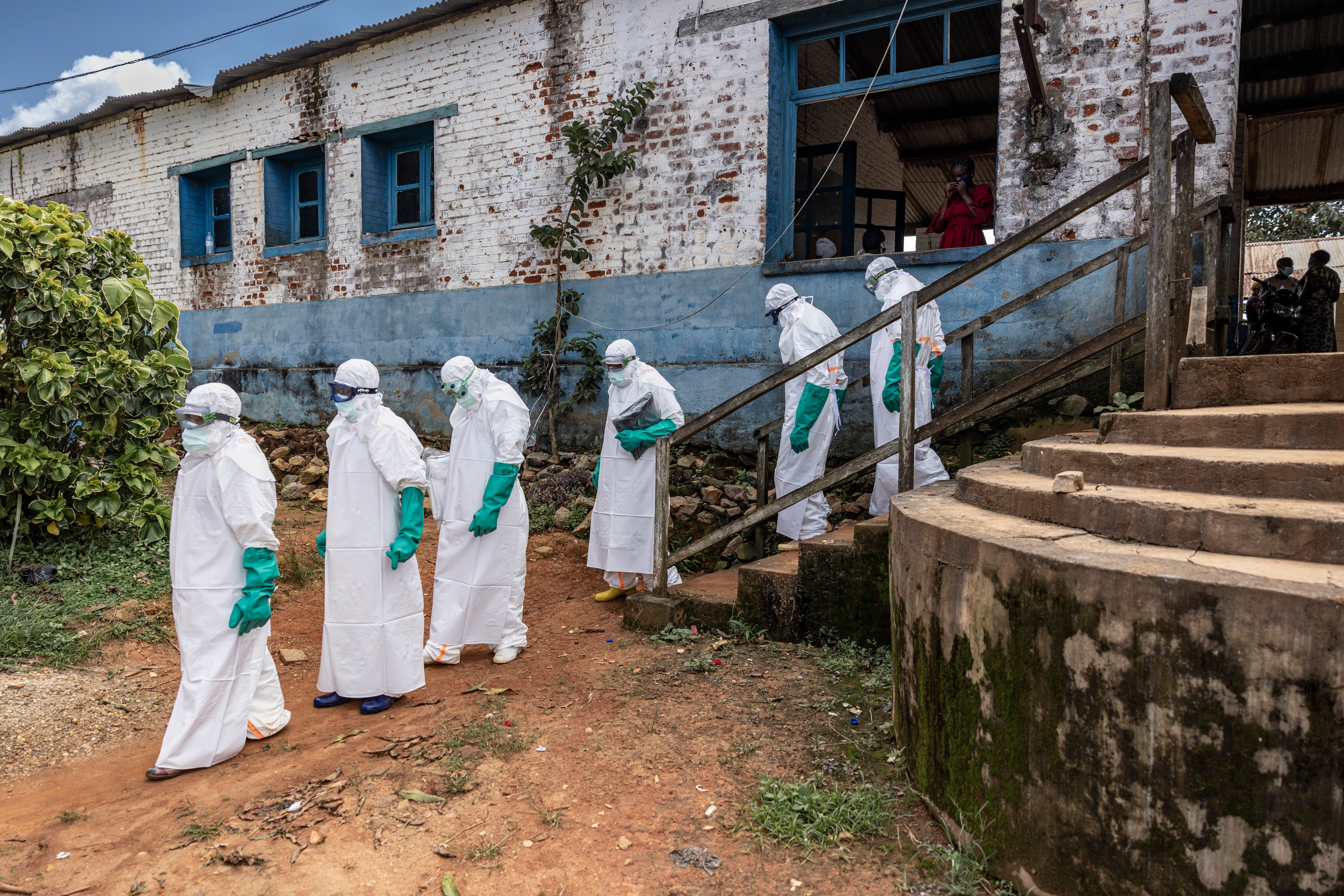 Health workers wearing protective equipment walk outside the General Referral Hospital during the Ebola outbreak response in Mongbwalu, Democratic Republic of Congo, May 21, 2026.