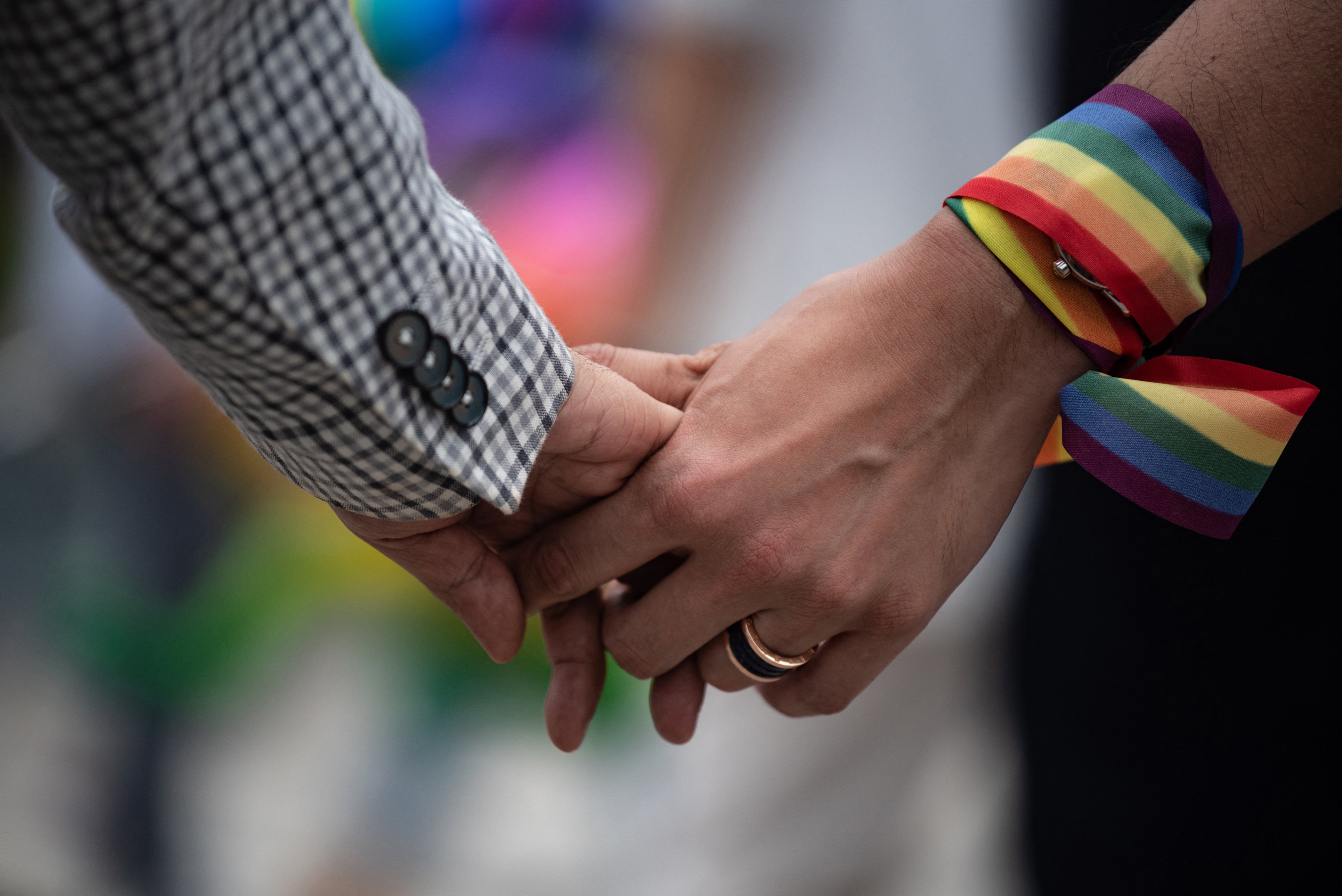 A same-sex couple hold hands during an event to raise awareness of gay rights in Hong Kong on May 25, 2019. 