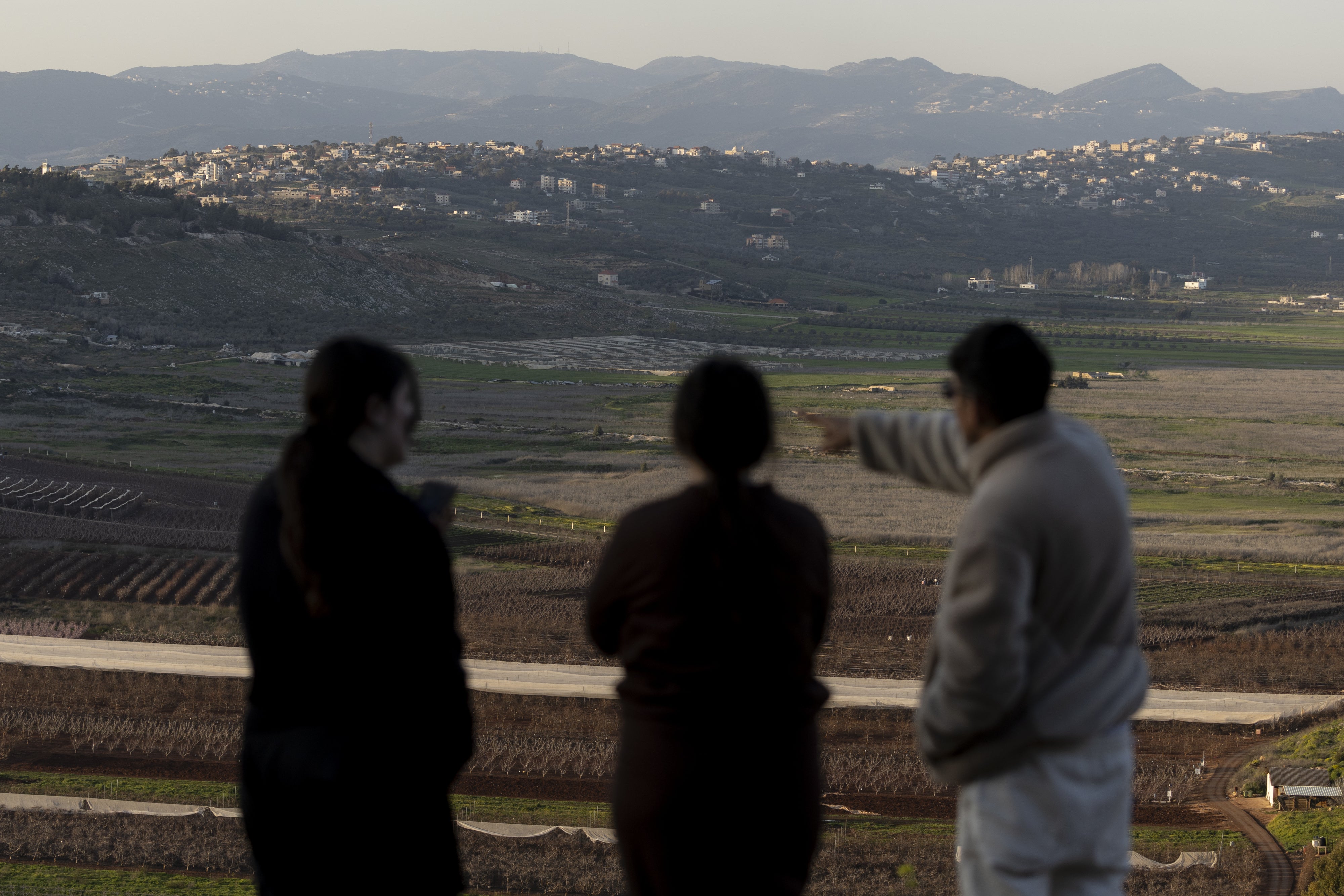 Israelis look at the border with Lebanon from a position in the northern village of Metula on March 5, 2026, after Hezbollah launched rockets at Israel during the ongoing conflict.