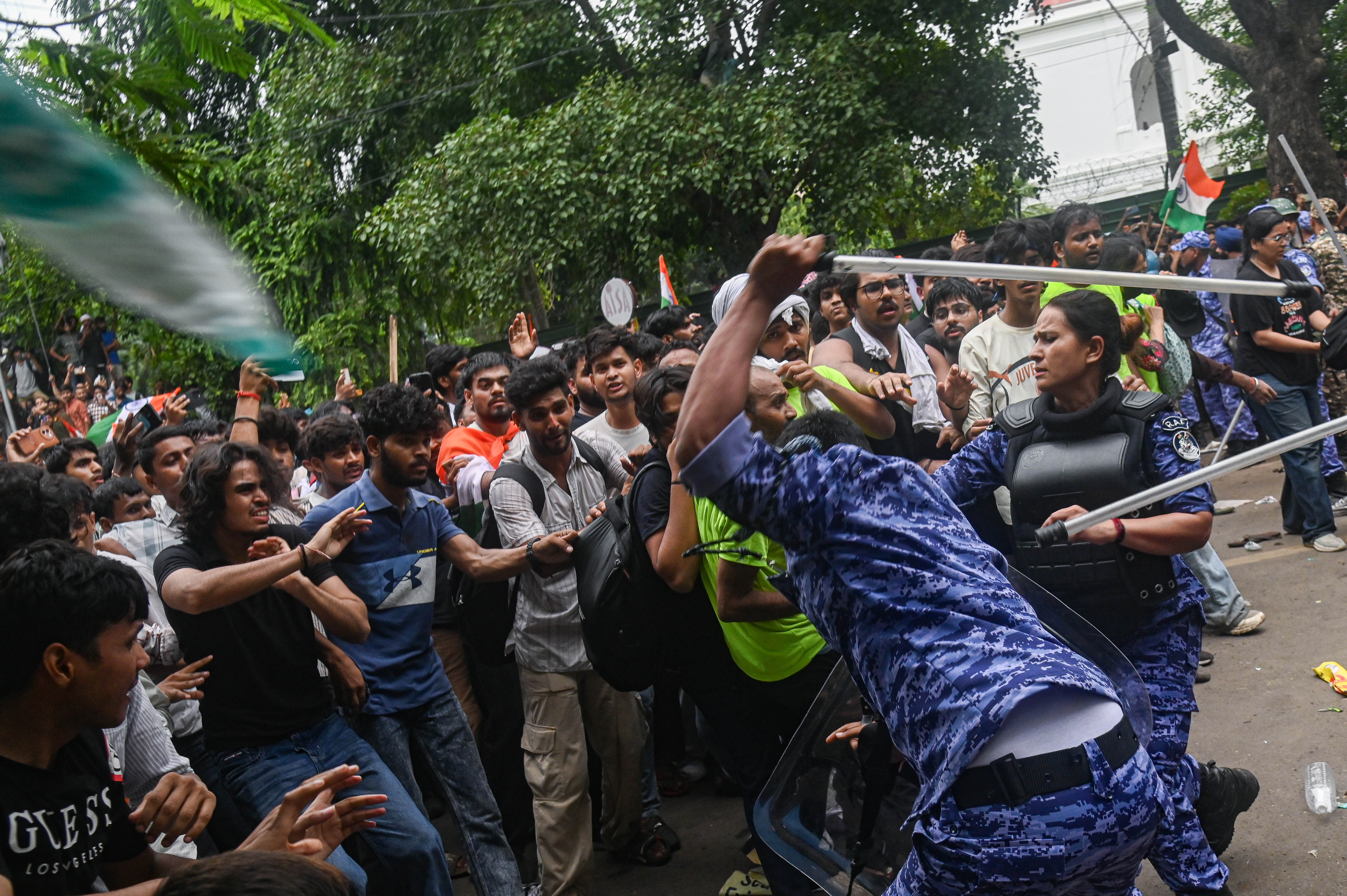 Police officers use batons to disperse protestors