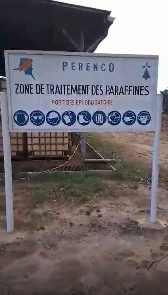 Corporate sign signaling a “Paraffin Treatment Zone” at the Perenco waste facility near Kinkazi village, Democratic Republic of Congo.