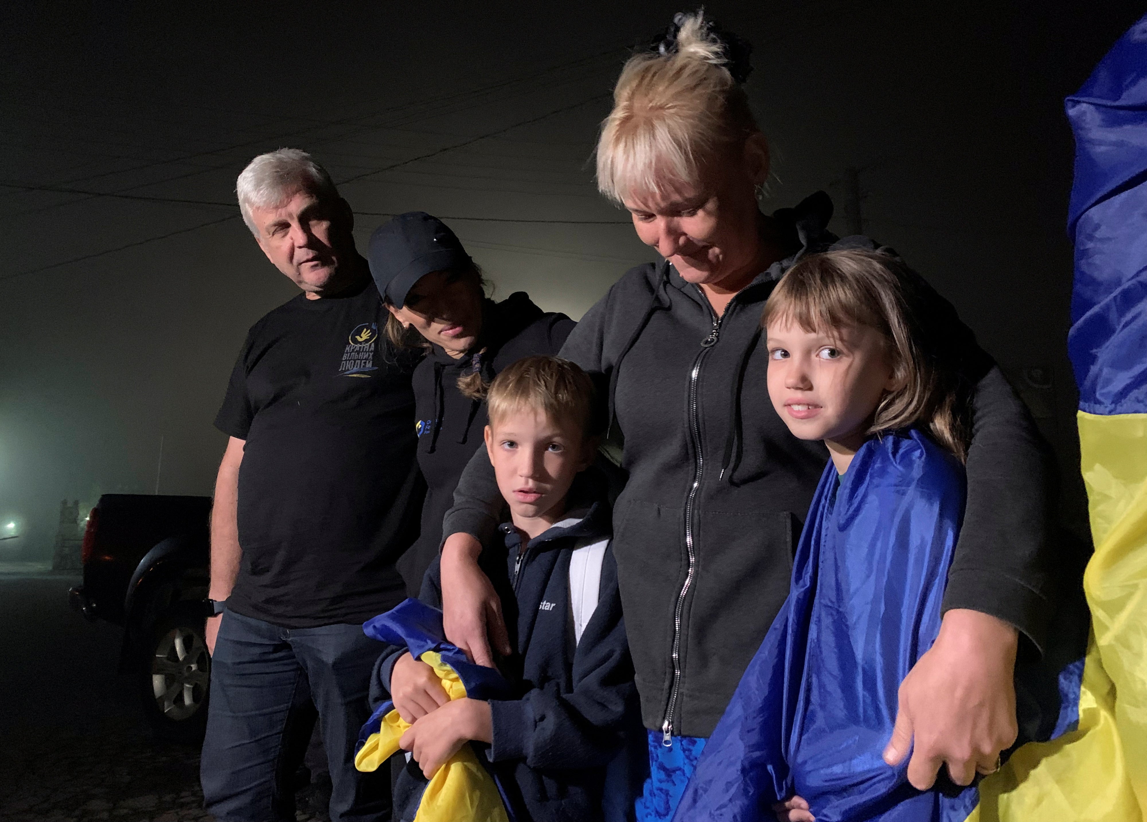A mother hugs her children after their return from the occupied territory of Ukraine via the Ukraine-Belarus border, amid Russia's attack on Ukraine, in Volyn region, Ukraine, on September 3, 2023.