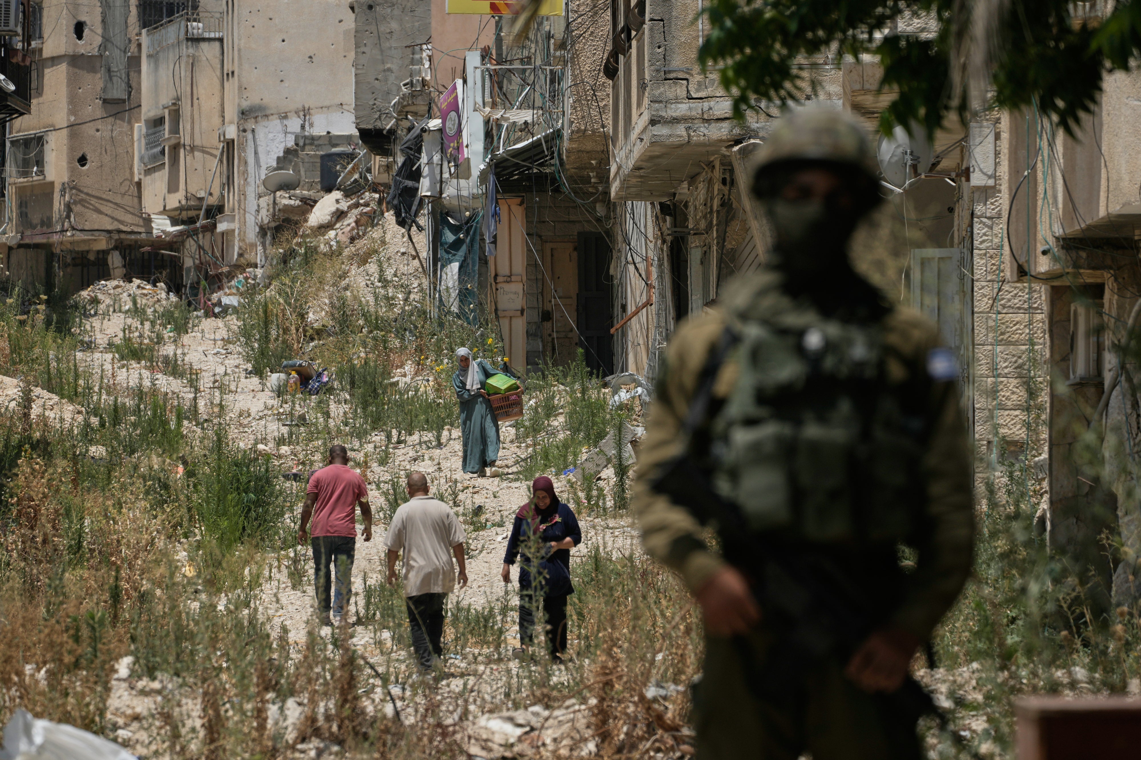 Palestinians collect their belongings from their evacuated homes after the Israeli army issued a number of short-term access permits for residents of the occupied West Bank refugee camp of Tulkarem, June 17, 2026. 