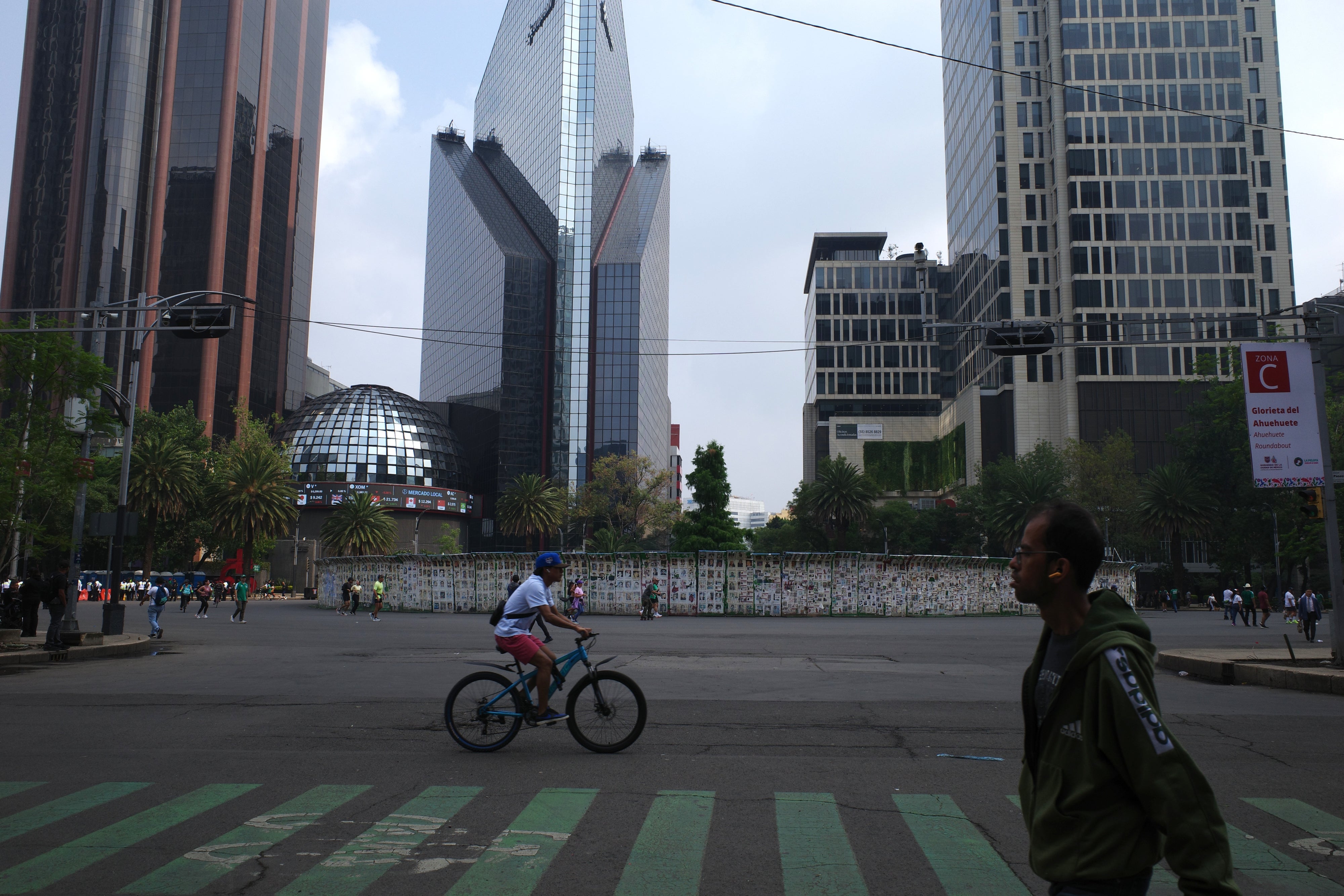 One of the government barriers surrounding the site bears the message: "130,000 disappeared."