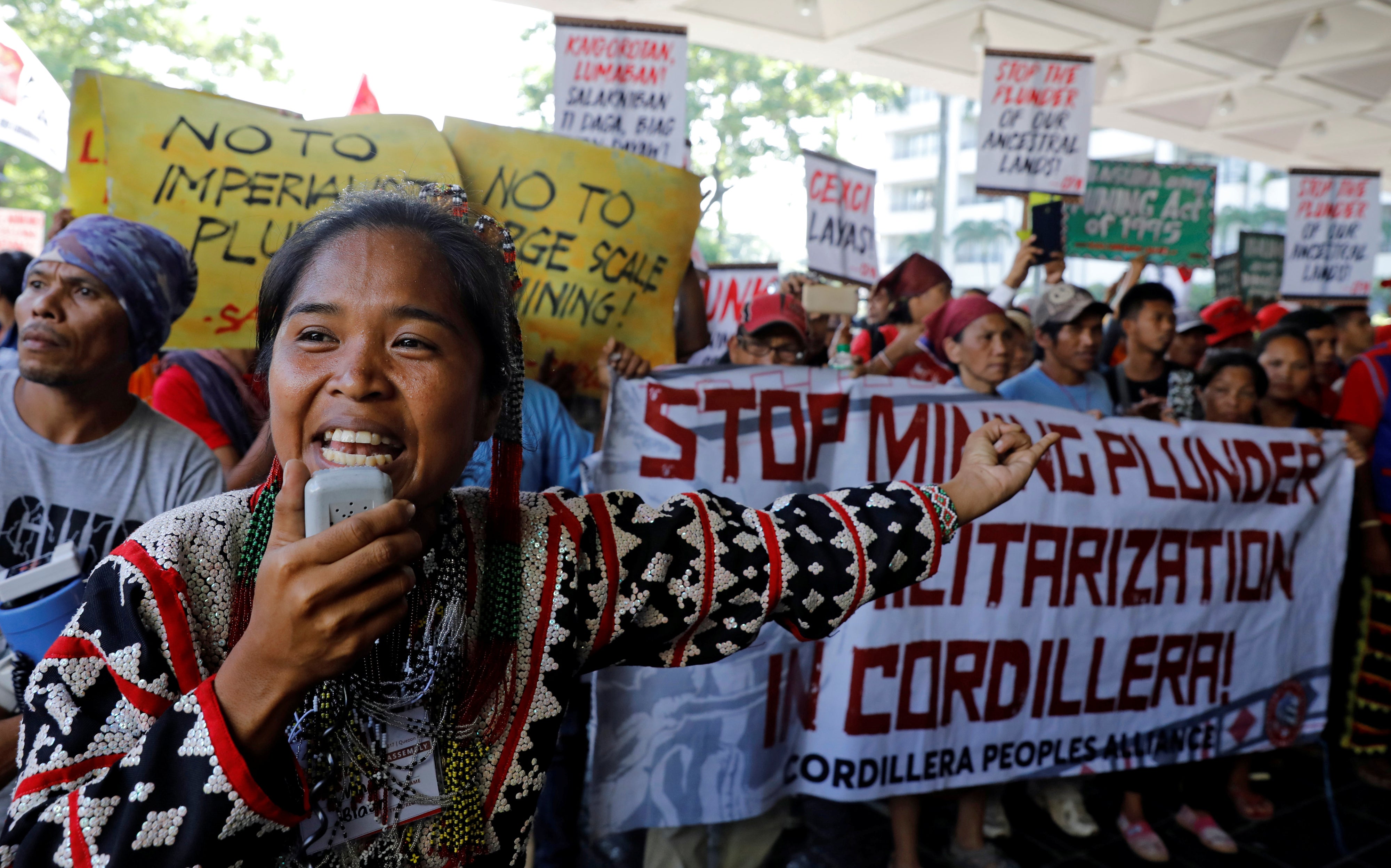 An anti-mining protester speaks during a rally outside the annual Philippines mining conference in Pasay, Metro Manila, September 6, 2017.