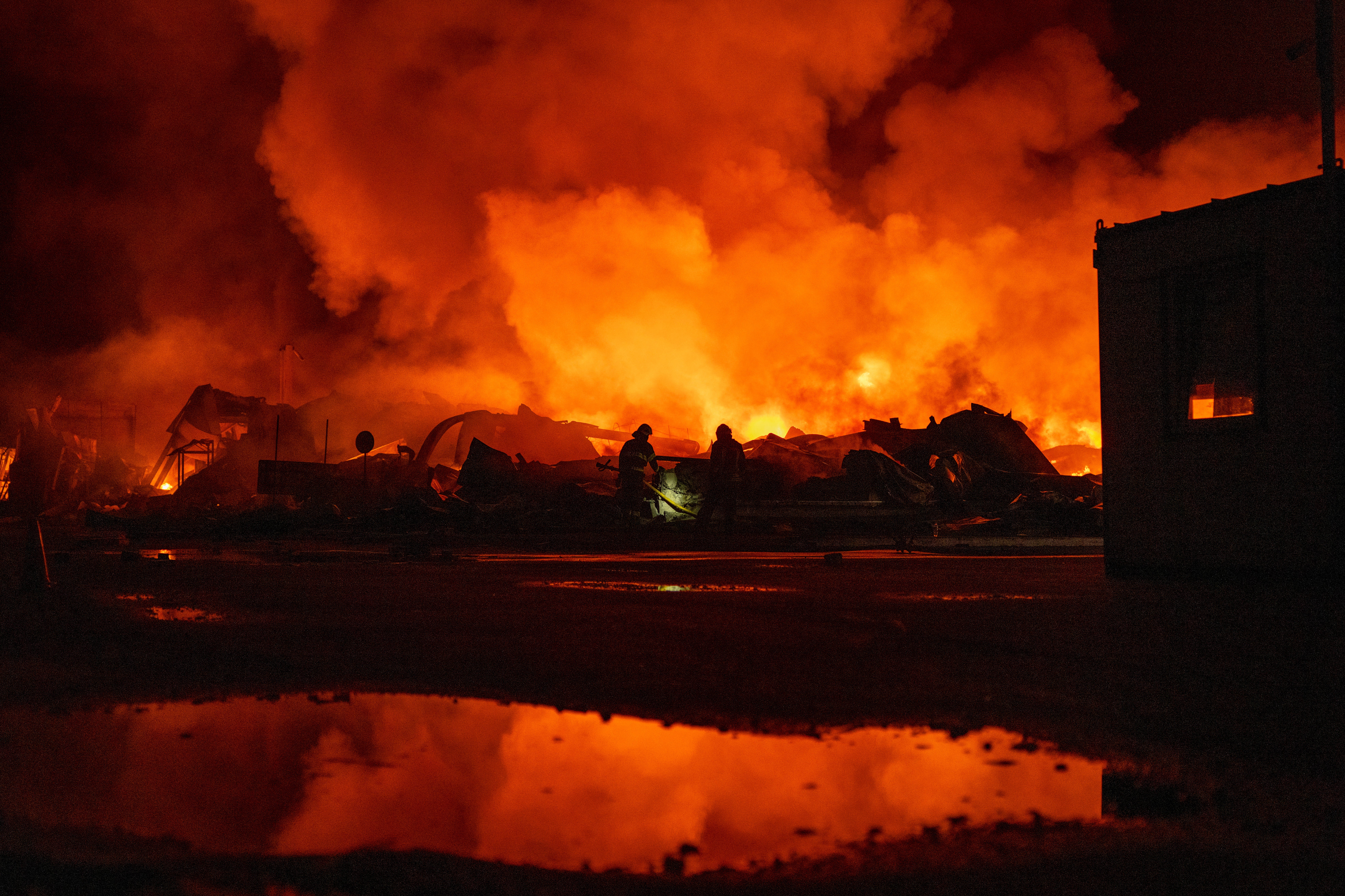 Firefighters put out a fire after Russian missiles hit a warehouse in Kyiv, Ukraine, on August 5, 2026. 