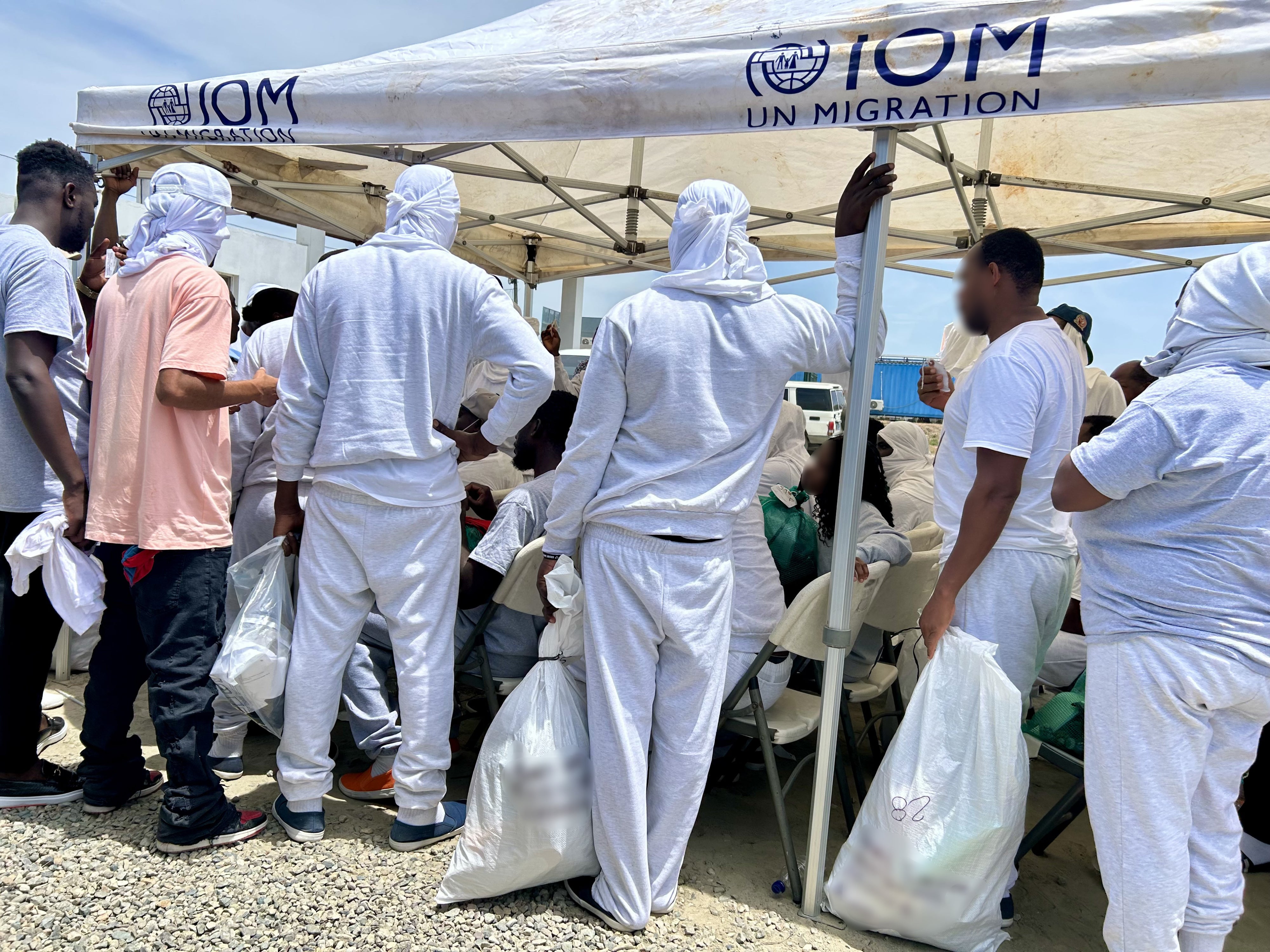 Haitians deported from the United States wait to be registered after arriving at Cap-Haïtien International Airport, Haiti, August 27, 2026.