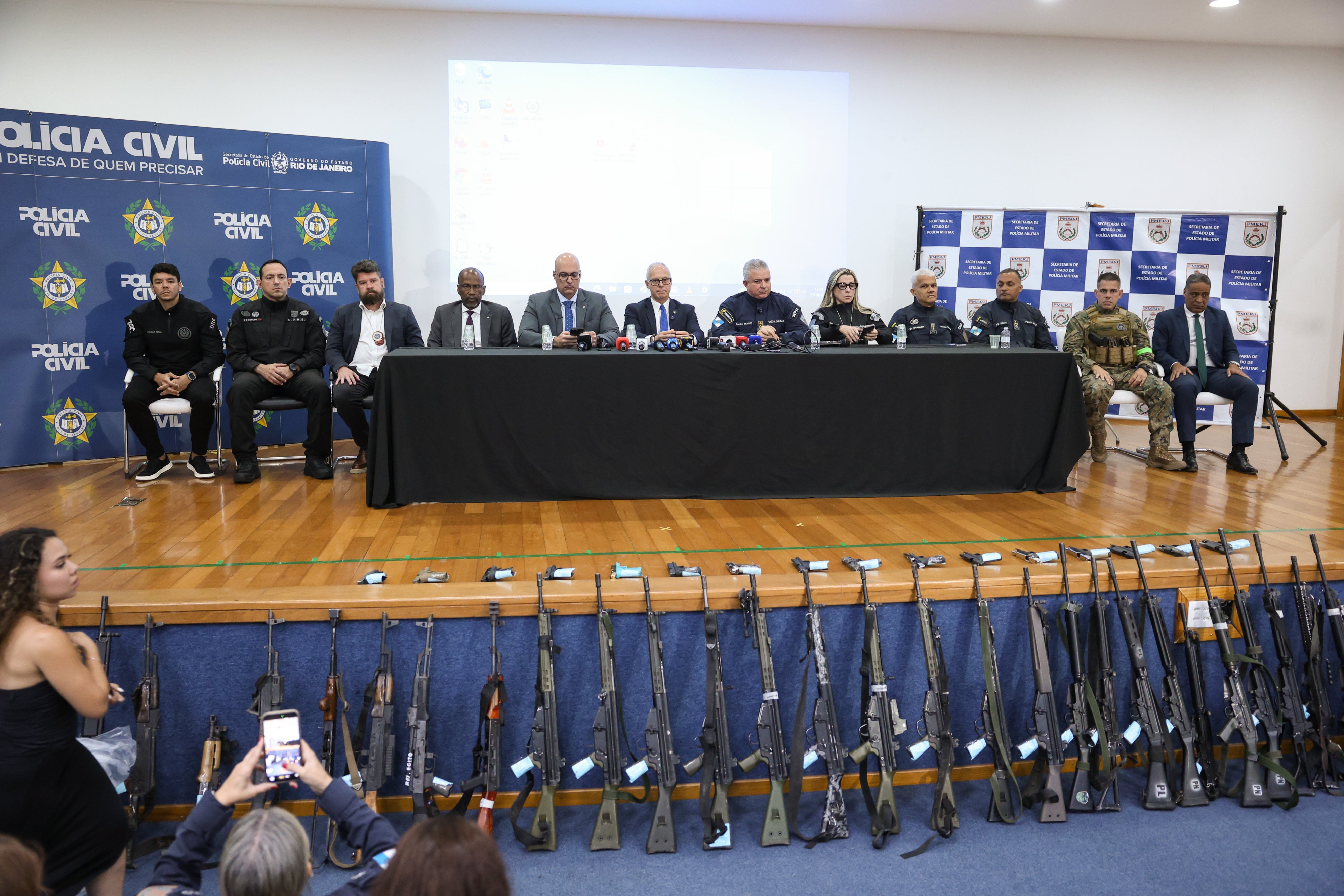 People on a stage holding a press conference